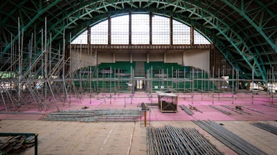 An interior construction scene showing the renovation process of the Tenis Club of the Pacaembu Sports Complex by RADDAR