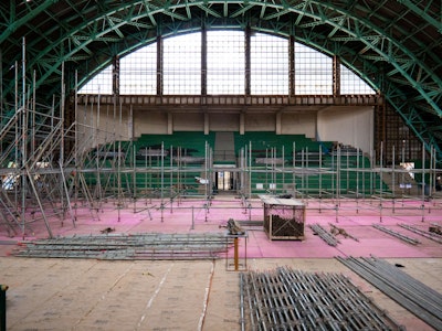 An interior construction scene showing the renovation process of the Tenis Club of the Pacaembu Sports Complex by RADDAR