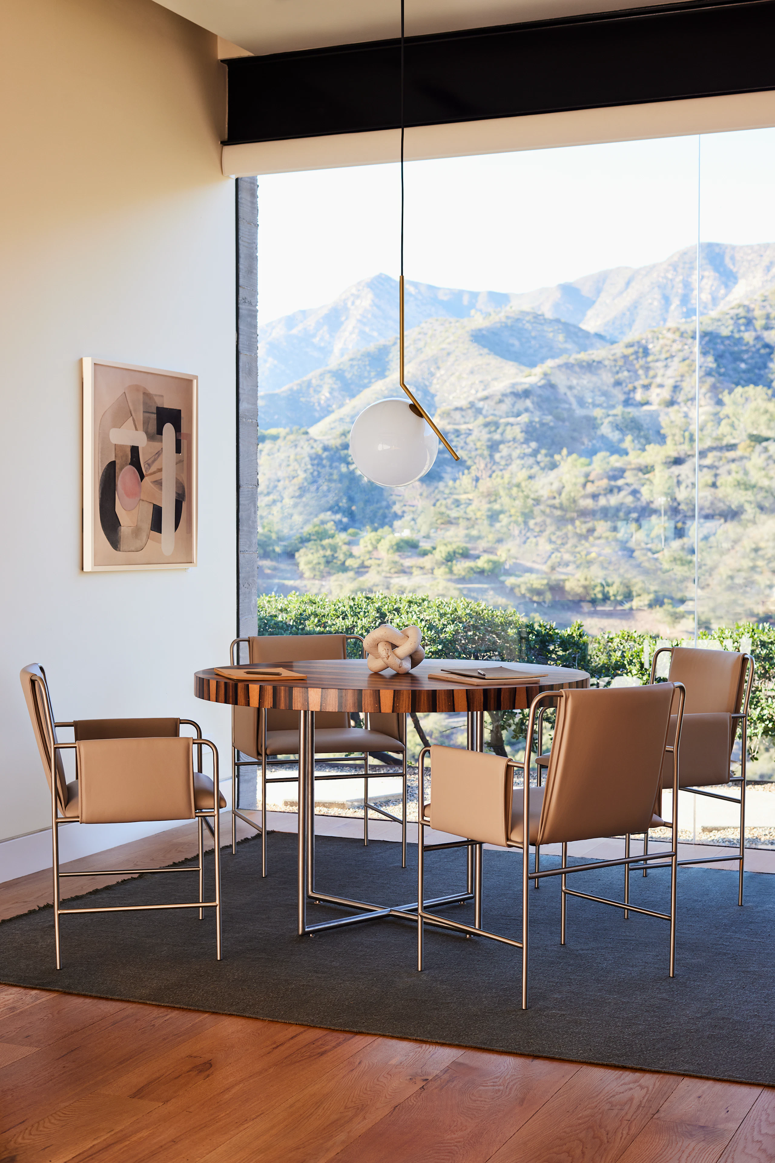 A meeting room with Domino Round meeting table and Envelope Chairs in an environmental setting.