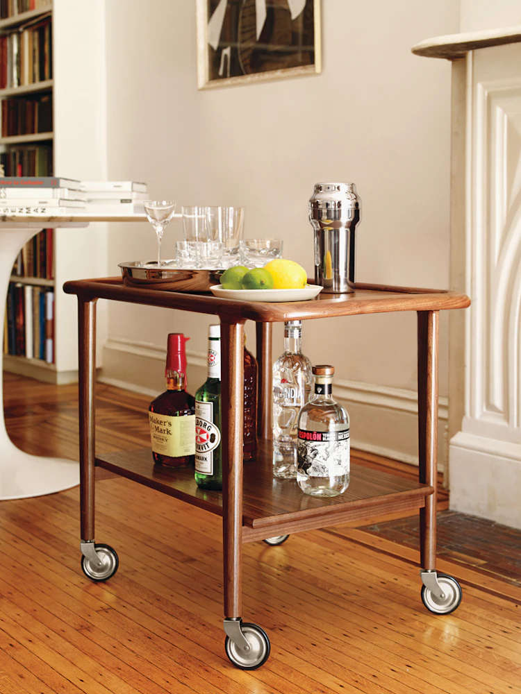 trolley used as bar cart with bottles on lower shelf