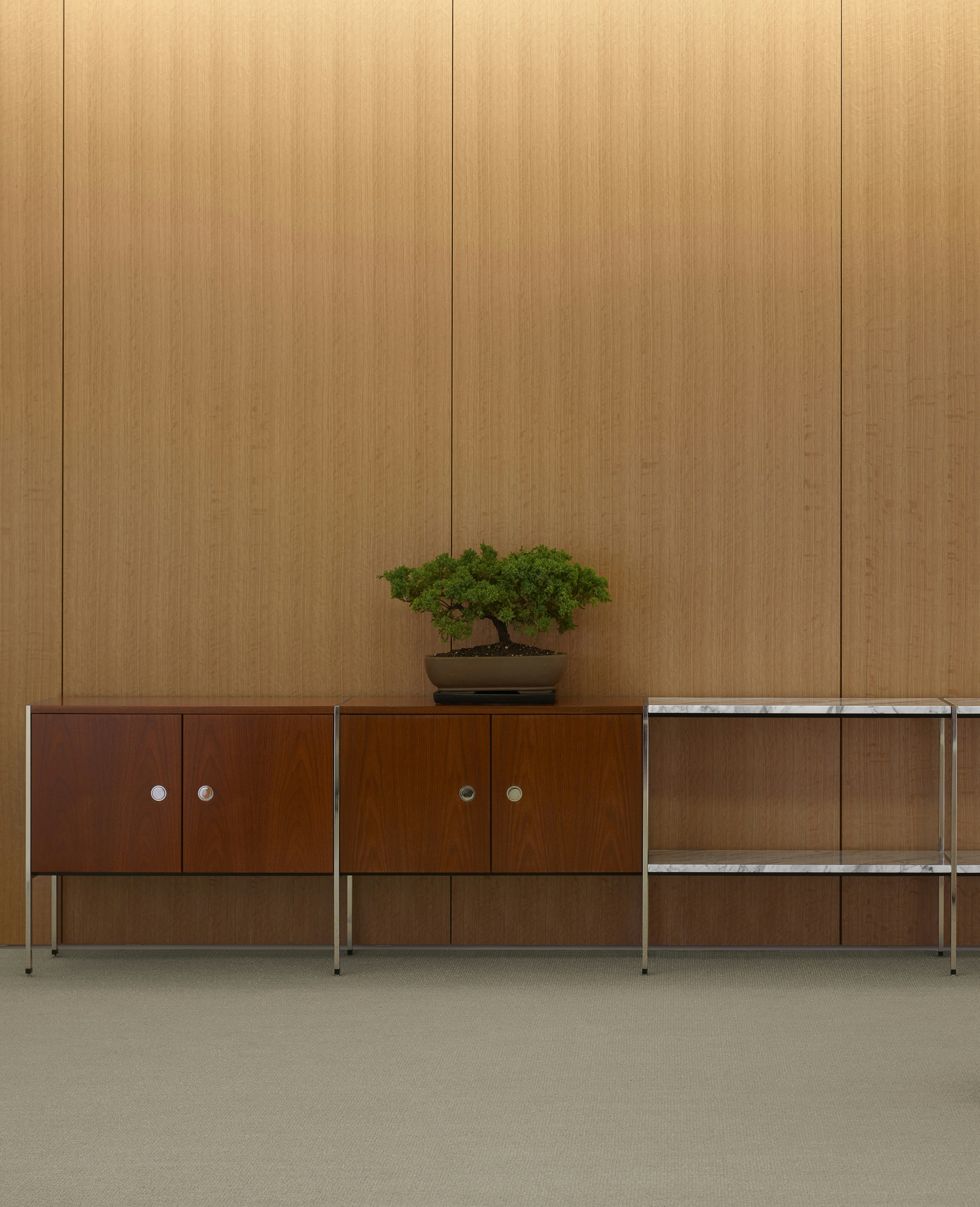 Partial view of an H Frame Storage credenza with enclosed cabinets and open shelving modules.
