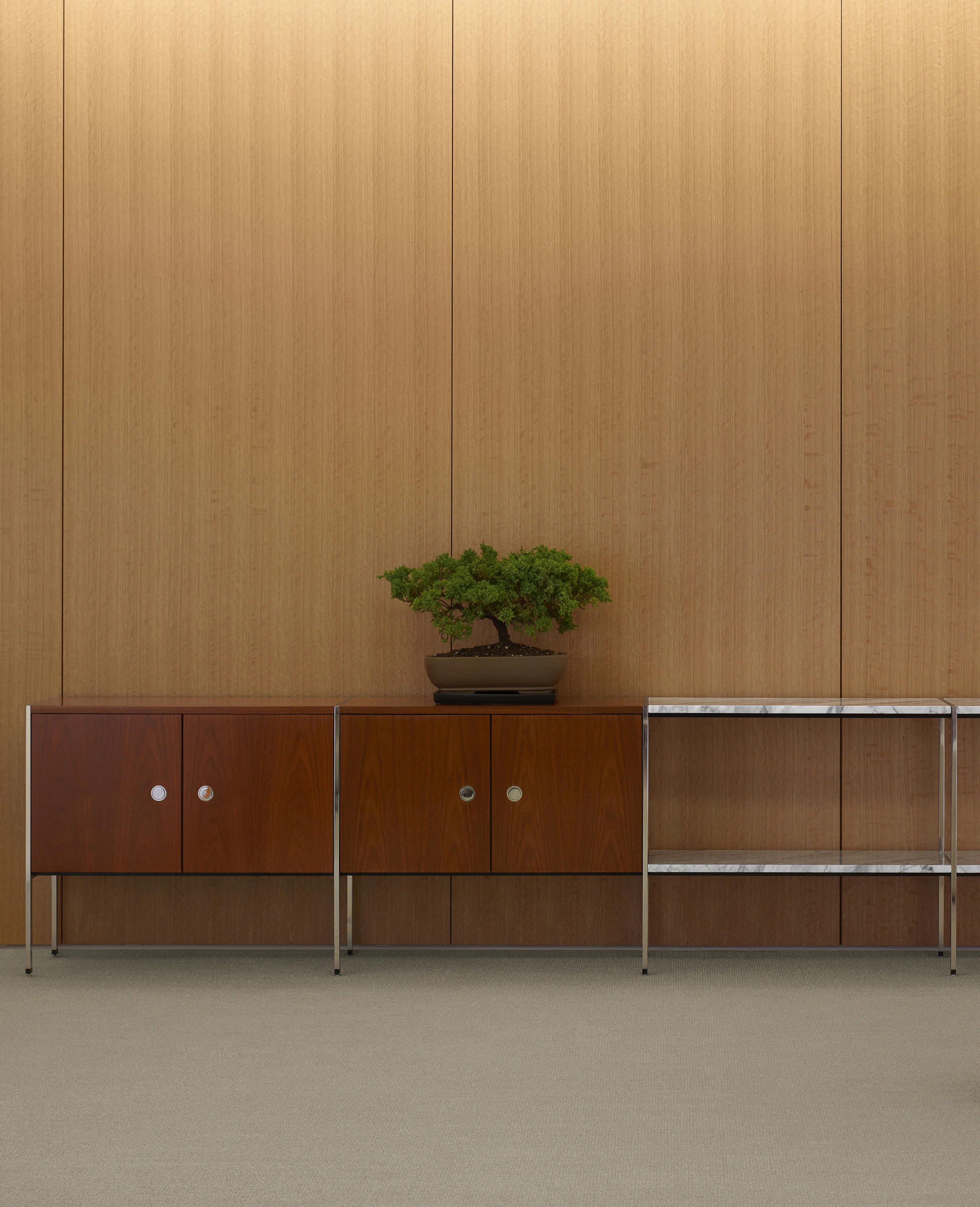 Partial view of an H Frame Storage credenza with enclosed cabinets and open shelving modules.