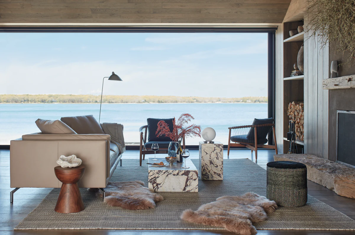 Outdoor-style living room with seating by a waterfront view