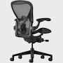 Black matte Aeron Chair on a white background with a 5-star base and ergonomic back support, angled view of the chair back.