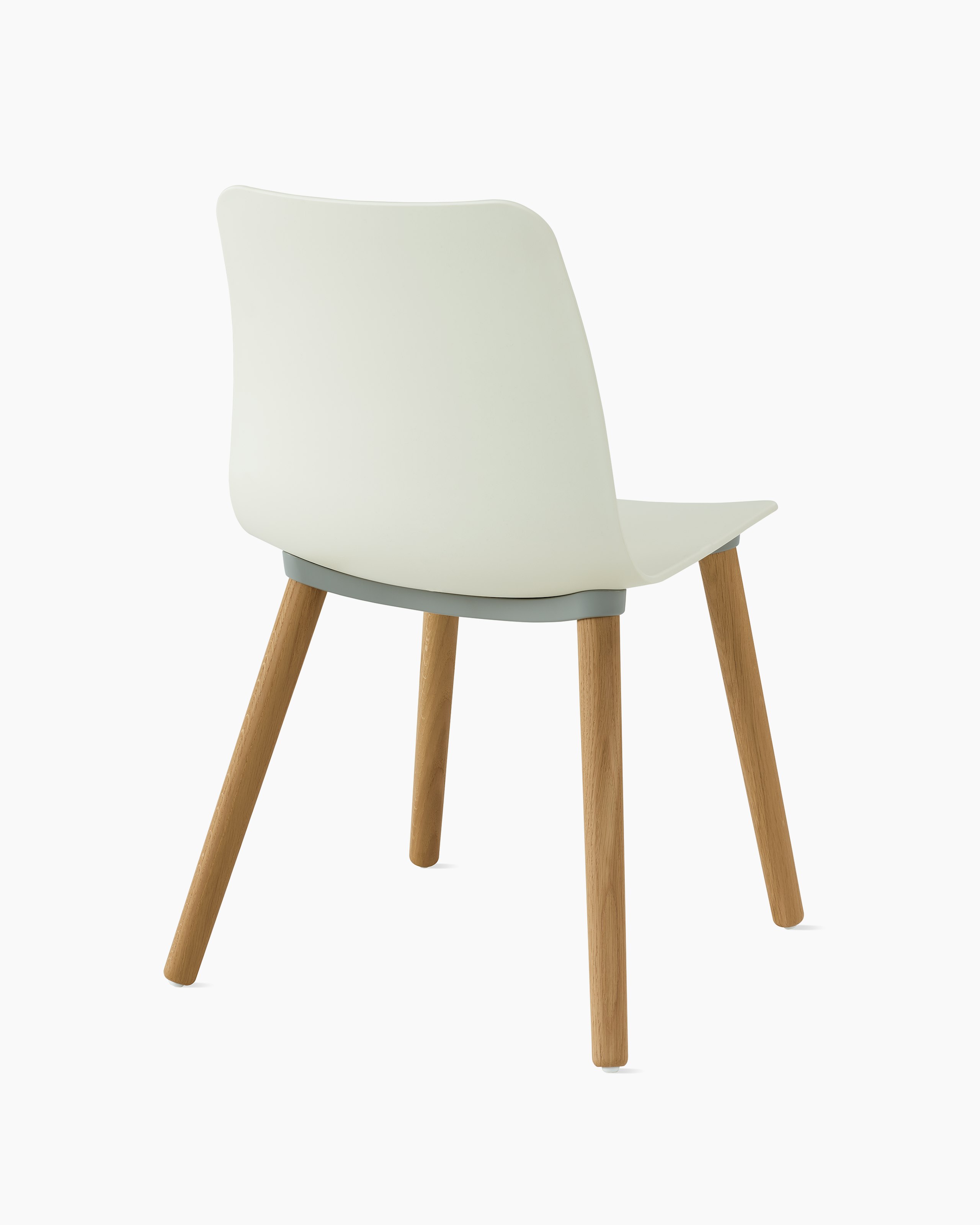 An oyster polypropylene chair with oak dowel base.
