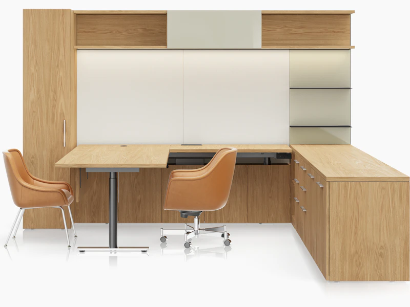 A Geiger One Private Office in Natural Flat Cut Oak with a Bumper Office and Side Chair in camel leather viewed from the front.