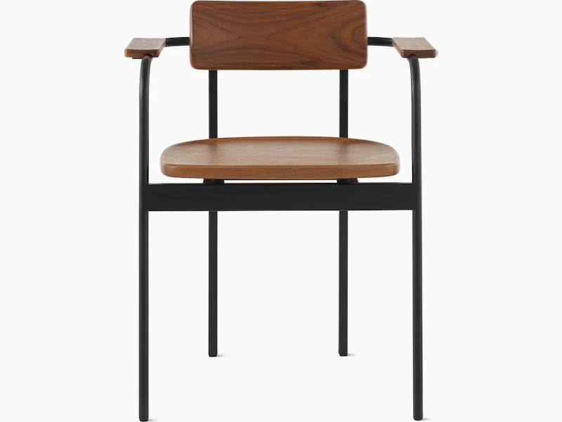 A Betwixt Chair with a walnut backrest, seat, and arms with a black frame.