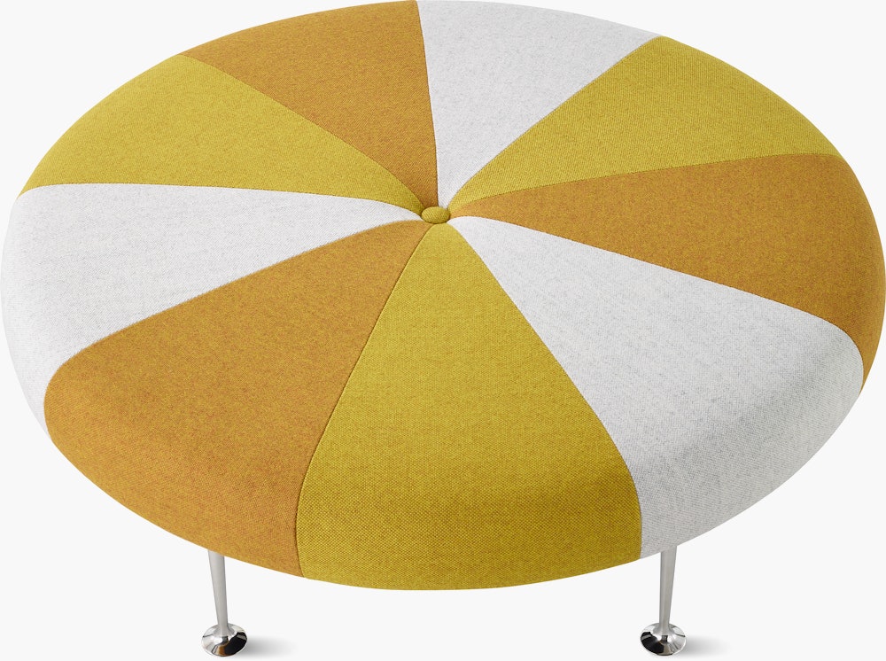 A Girard Color Wheel Ottoman upholstered in yellow fabrics, viewed from the top.