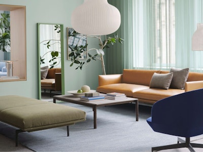 A sofa, upholstered bench, and chair arranged around a coffee table at the Muuto showroom at 251 Park Avenue South in New York City