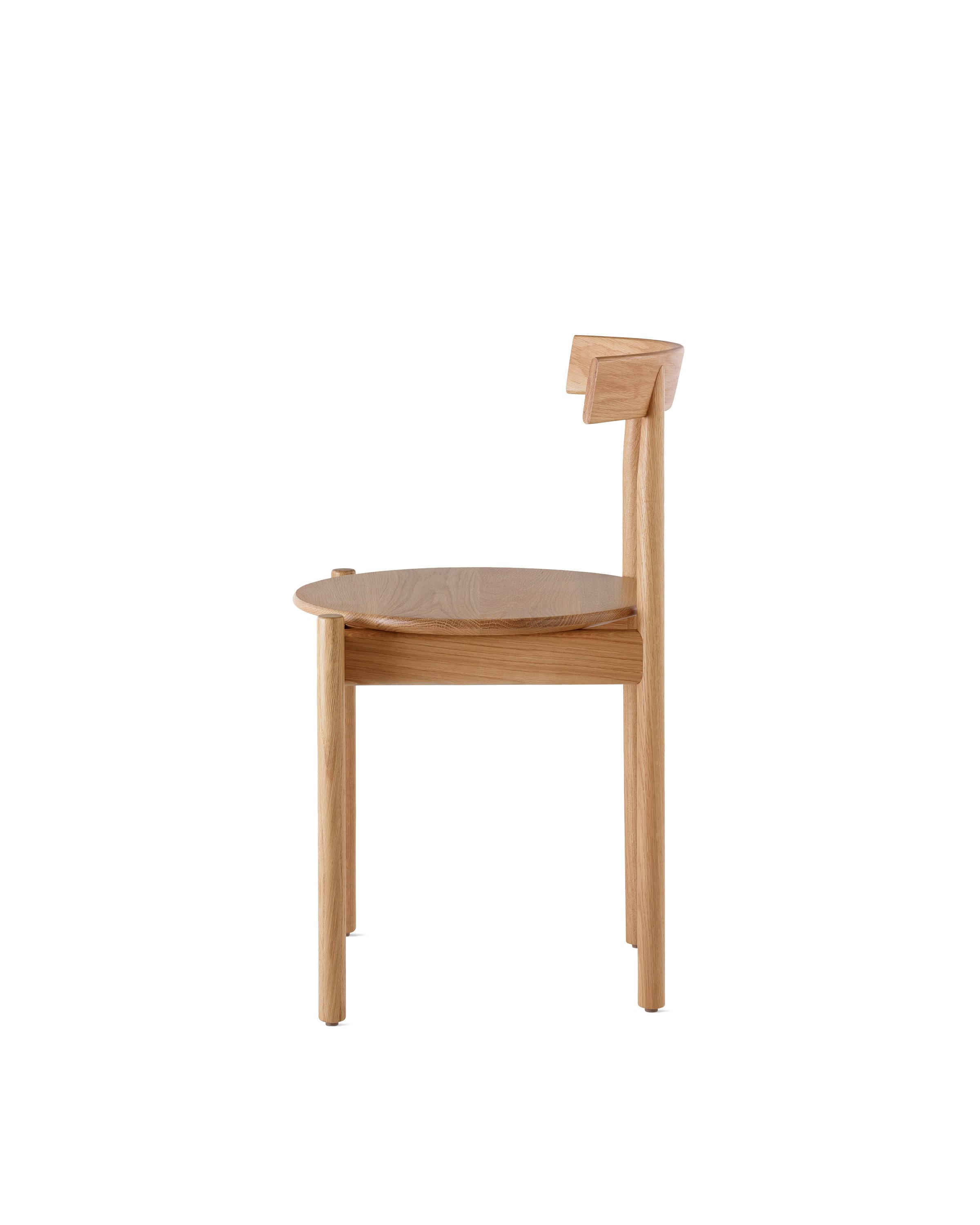Profile view of an oak Comma Chair.