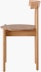 Profile view of an oak Comma Chair.
