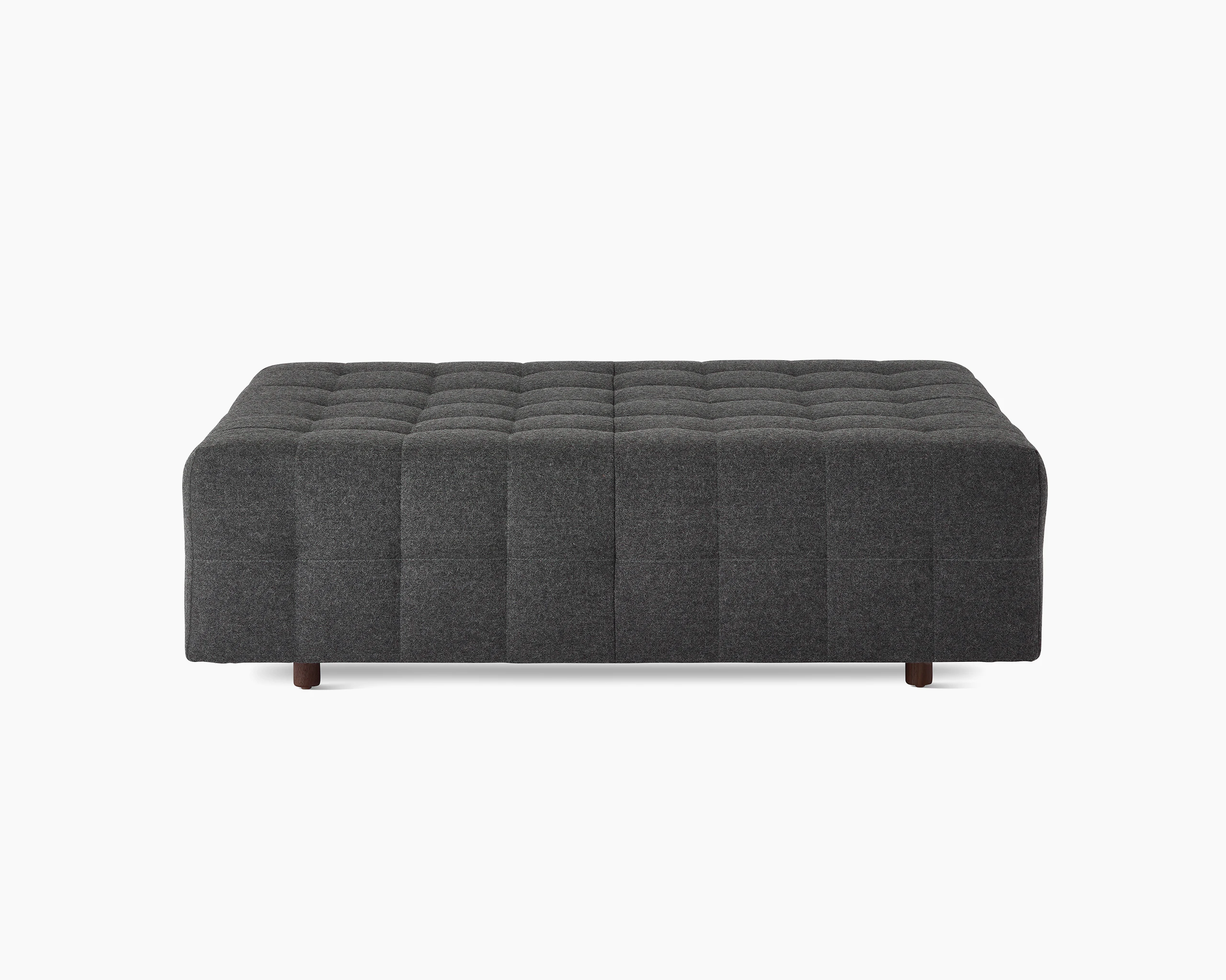 A Rapport ottoman upholstered in a dark grey fabric.