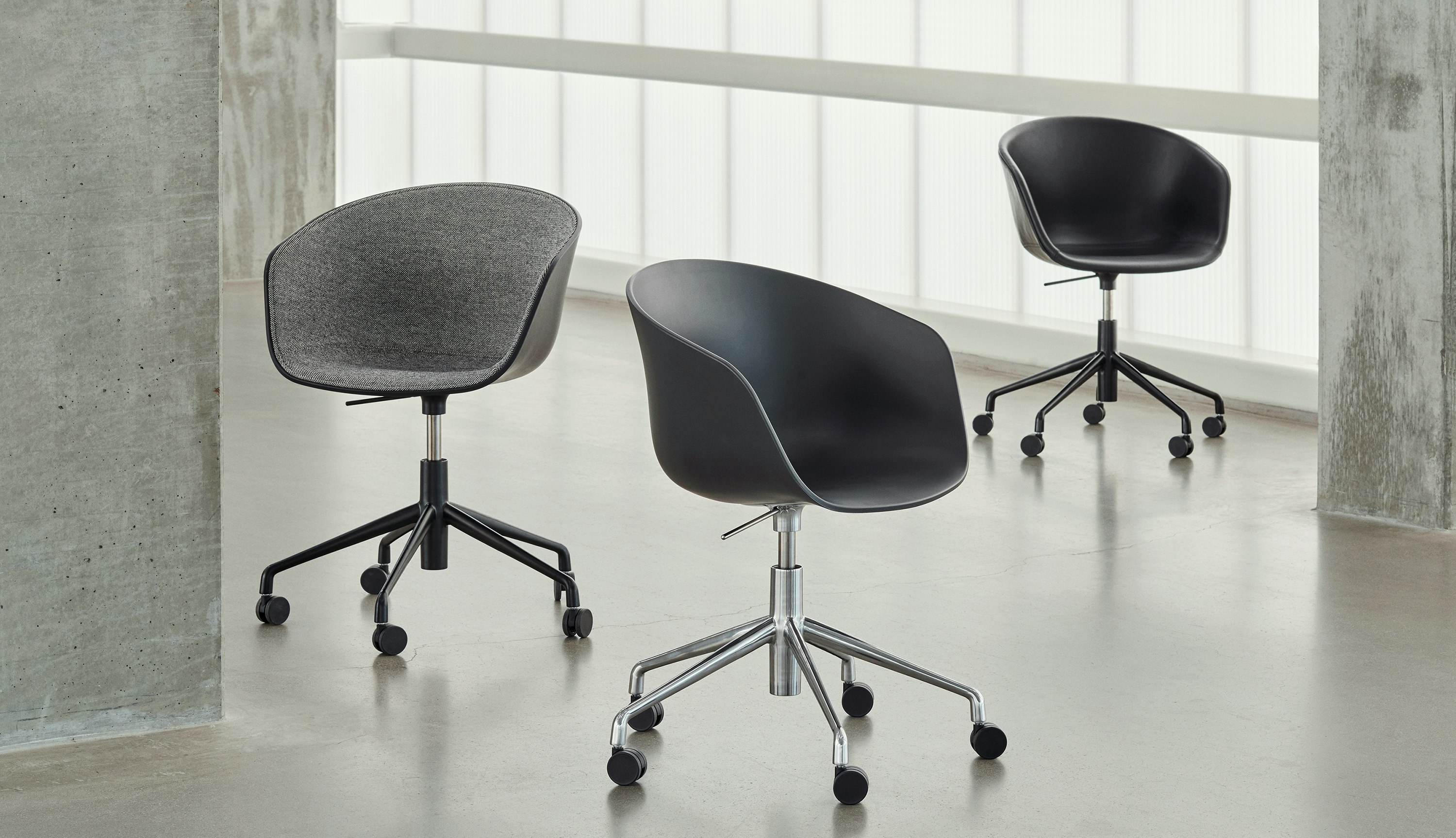 Three, 5-star swivel base About A Chair variations staged off-set from one another.