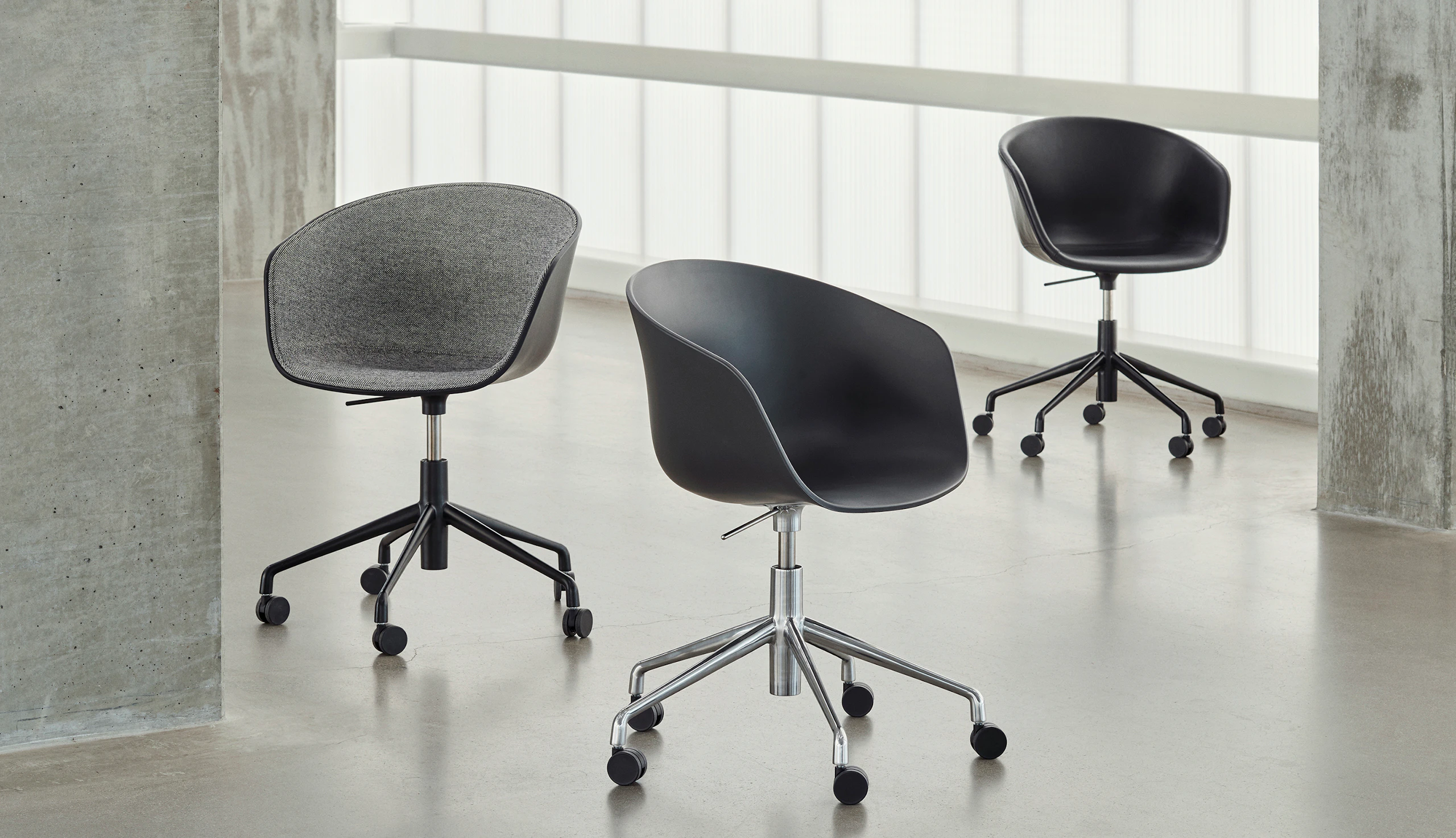 Three, 5-star swivel base About A Chair variations staged off-set from one another.