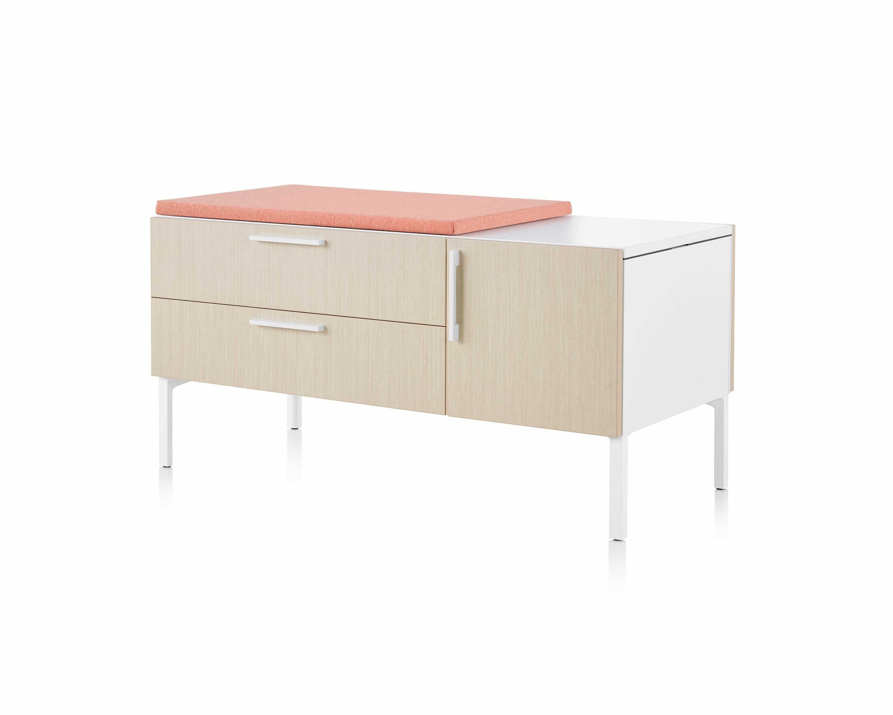 Light brown and white Tu Wood shared credenza with pink cushion top, box drawer, tip-out bin and door.