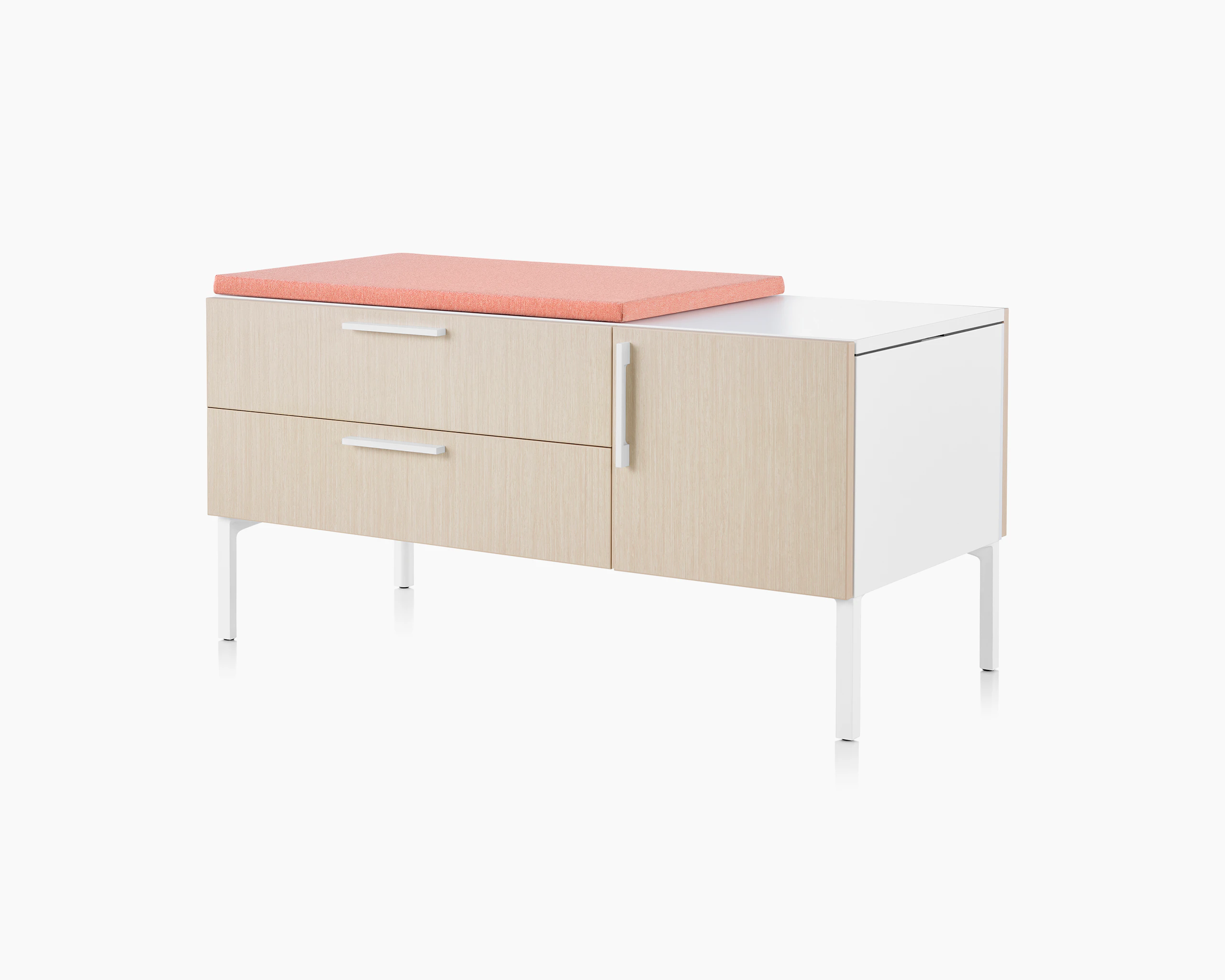 Light brown and white Tu Wood shared credenza with pink cushion top, box drawer, tip-out bin and door.