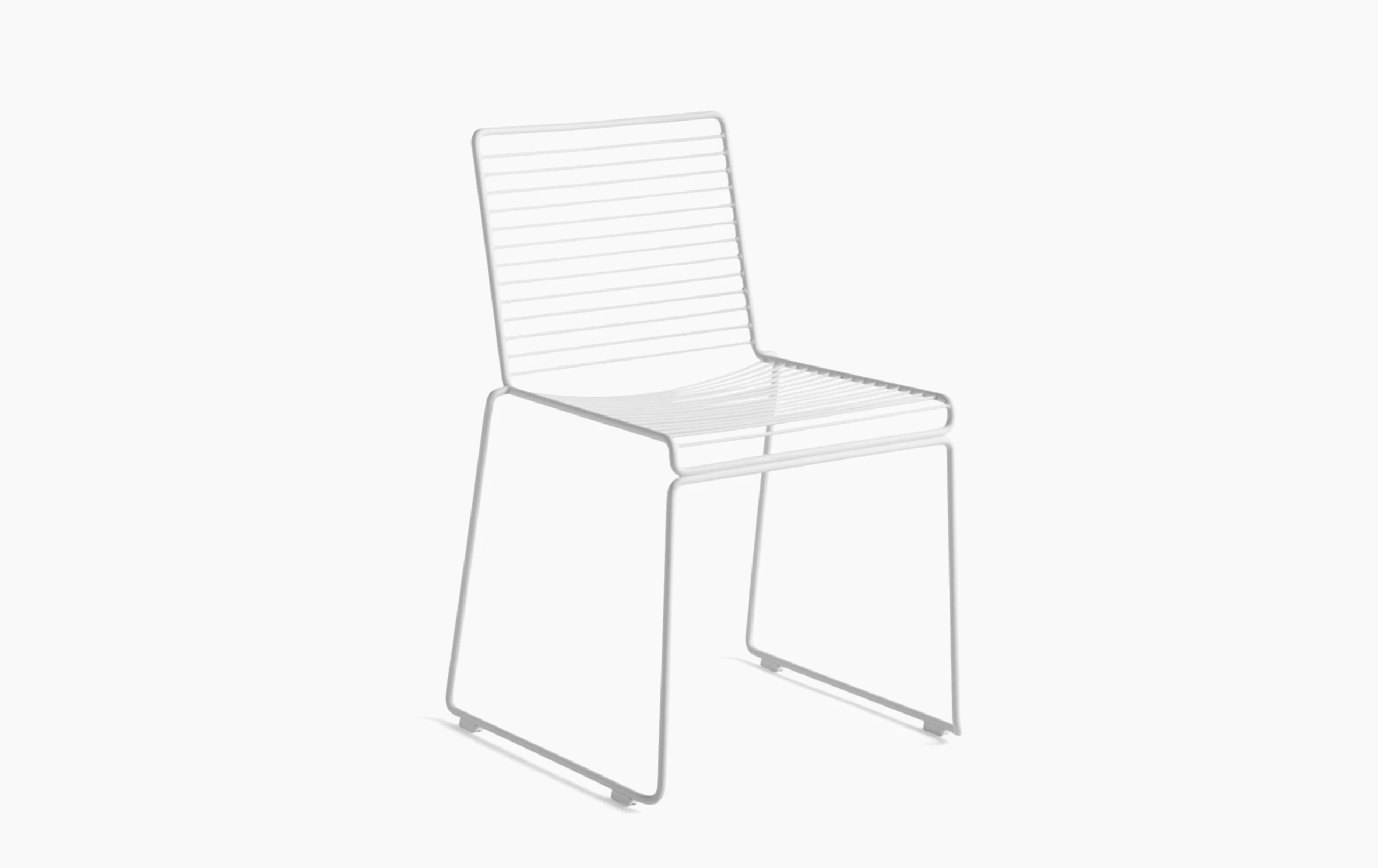 A three quarter angle view of a white Hee Dining Chair.