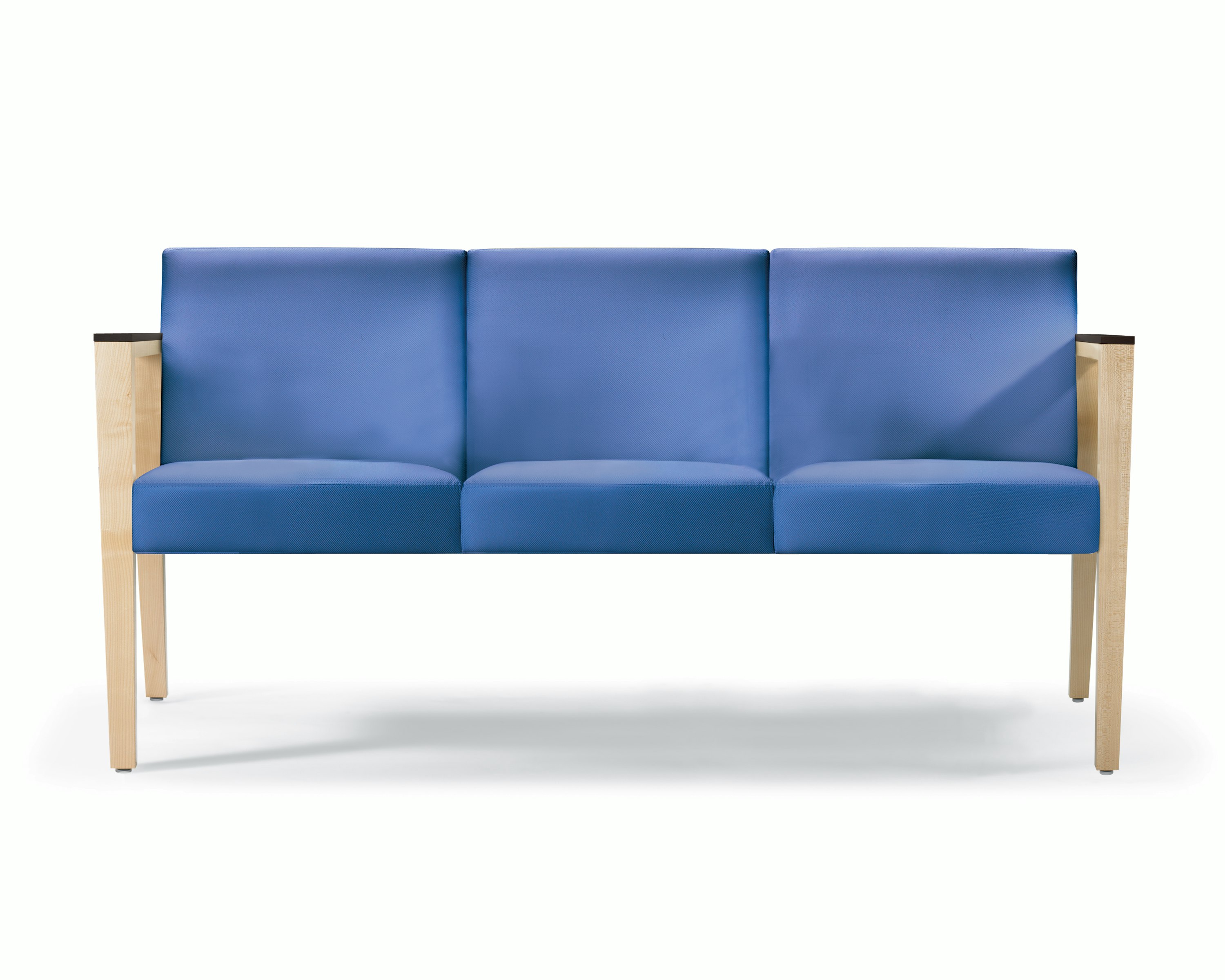 A front view of a Brava 863 Sofa in blue textile with maple base and urethane arm caps.