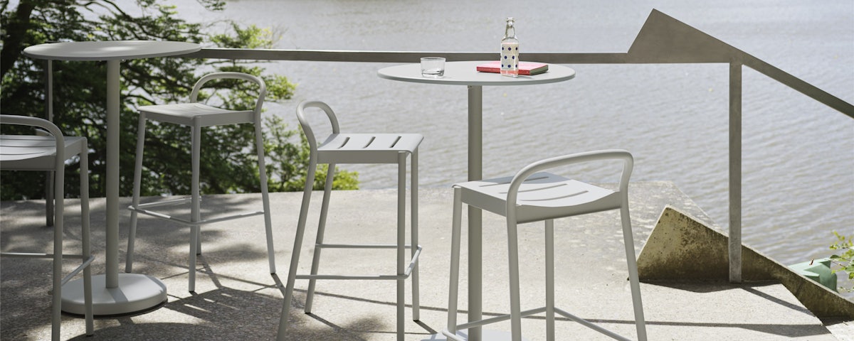 Linear Steel High Tables and High Stools in an outdoor setting