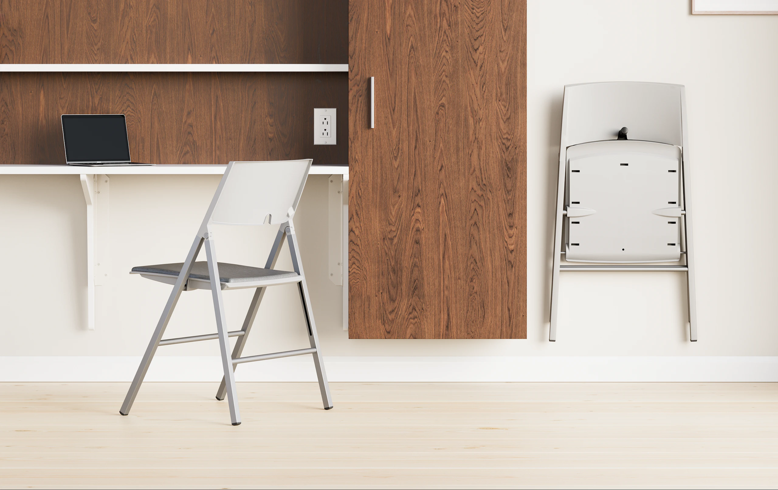 Detail of an Axa Folding Chair hanging on a hook in a patient room wall.