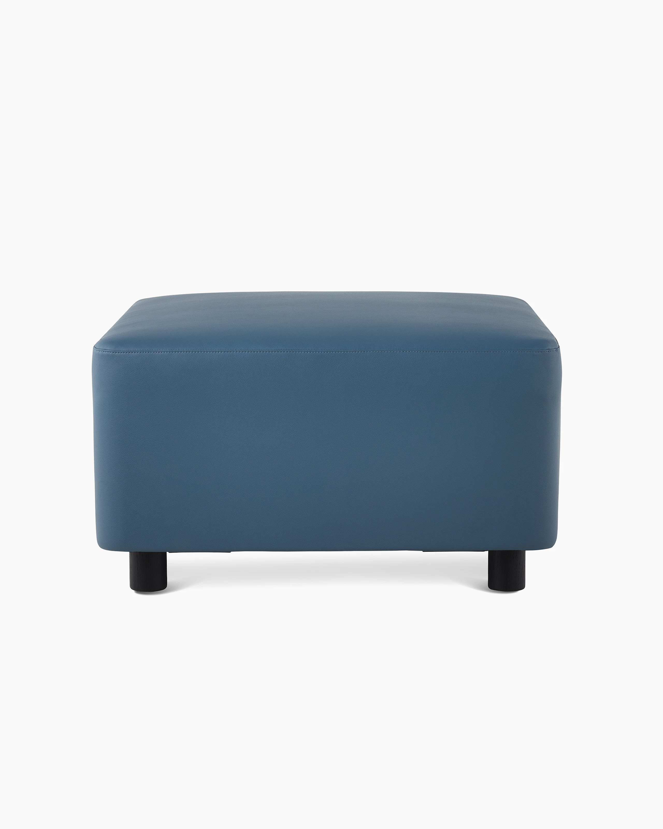 A Plex Ottoman in a blue upholstery.
