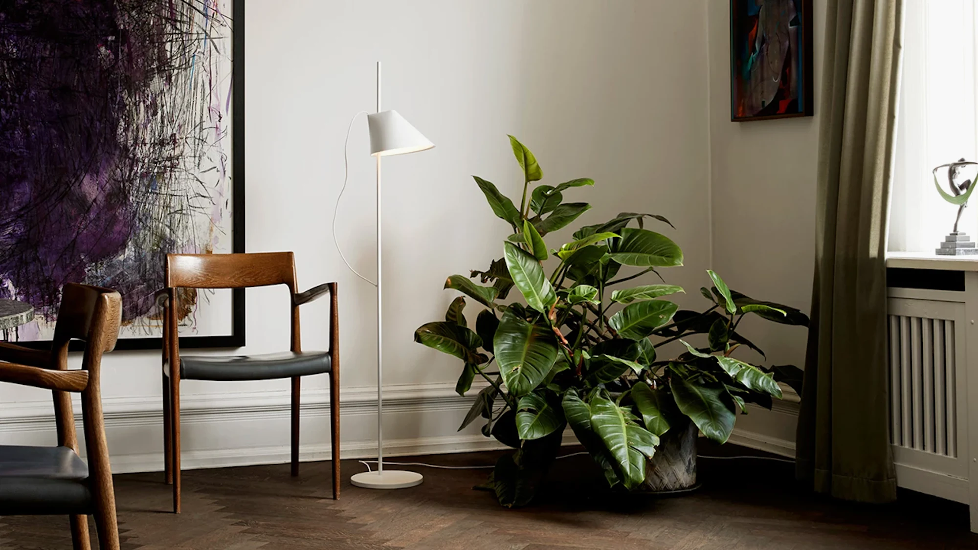 Moller Model 57 armchair with walnut frame and ivory leather seat in a room
