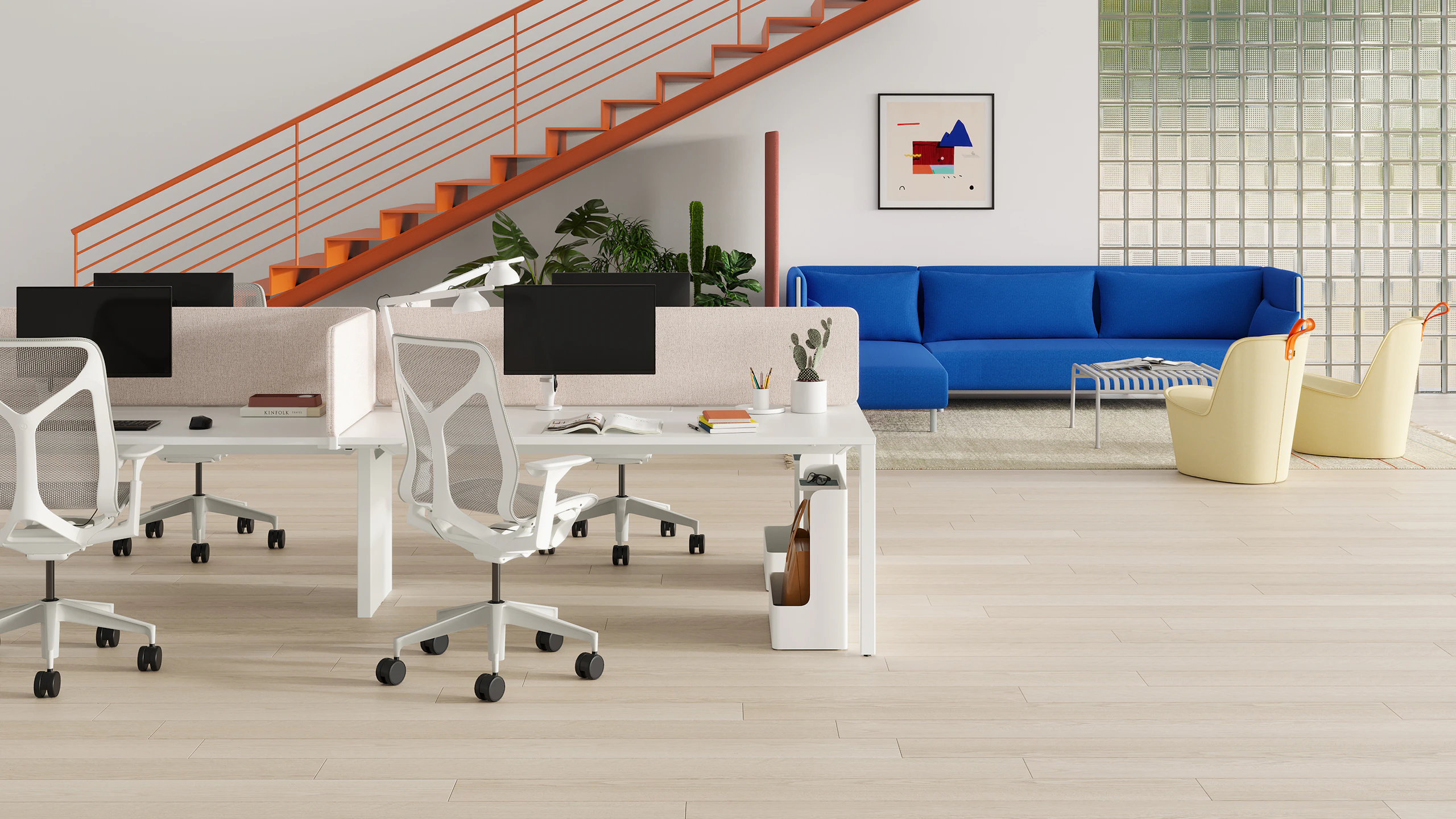 A bright workspace with colorful stairs ascending to the second level and additional ancillary seating in the background.