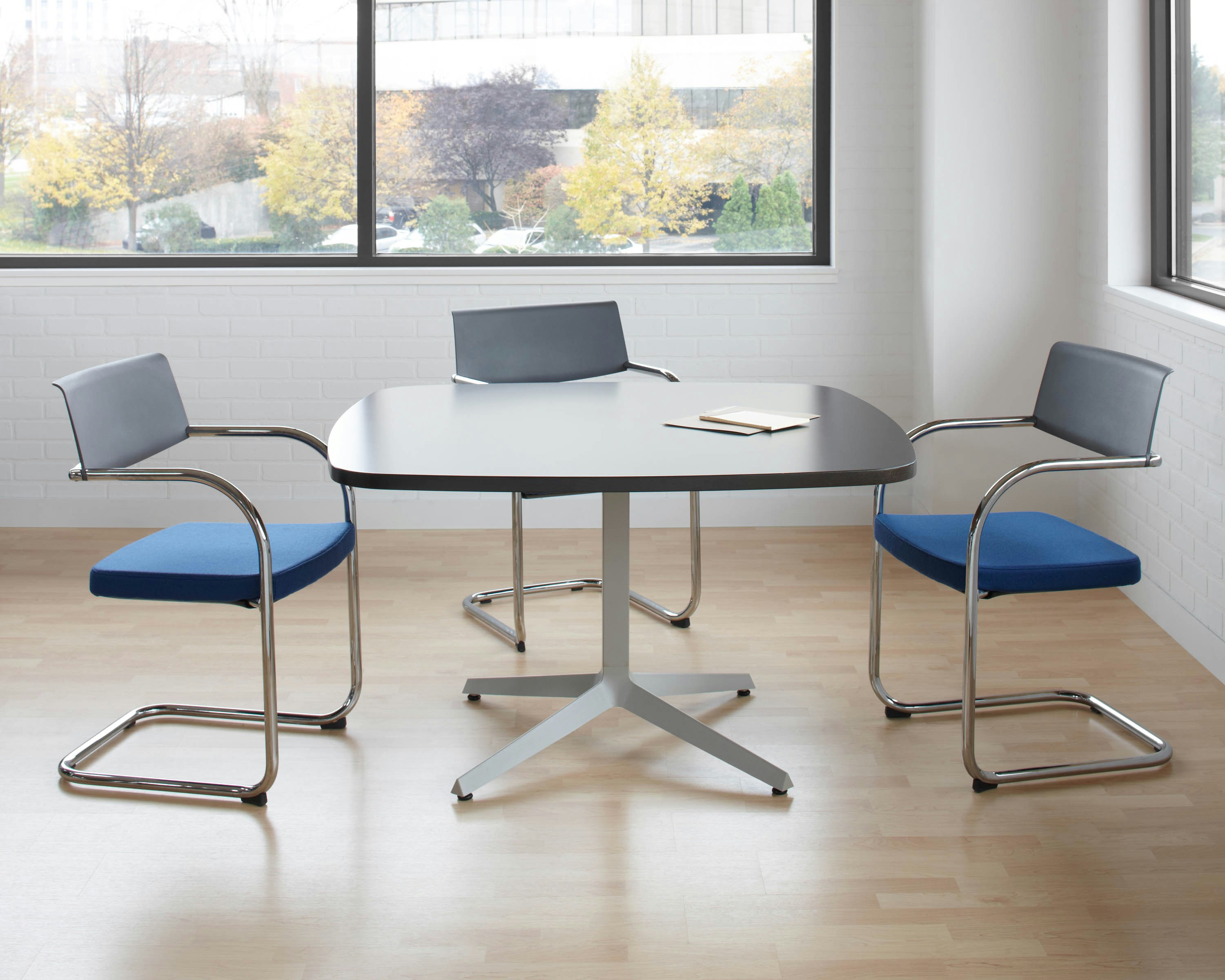 Dividends Skyline meeting table with Moment side chairs.