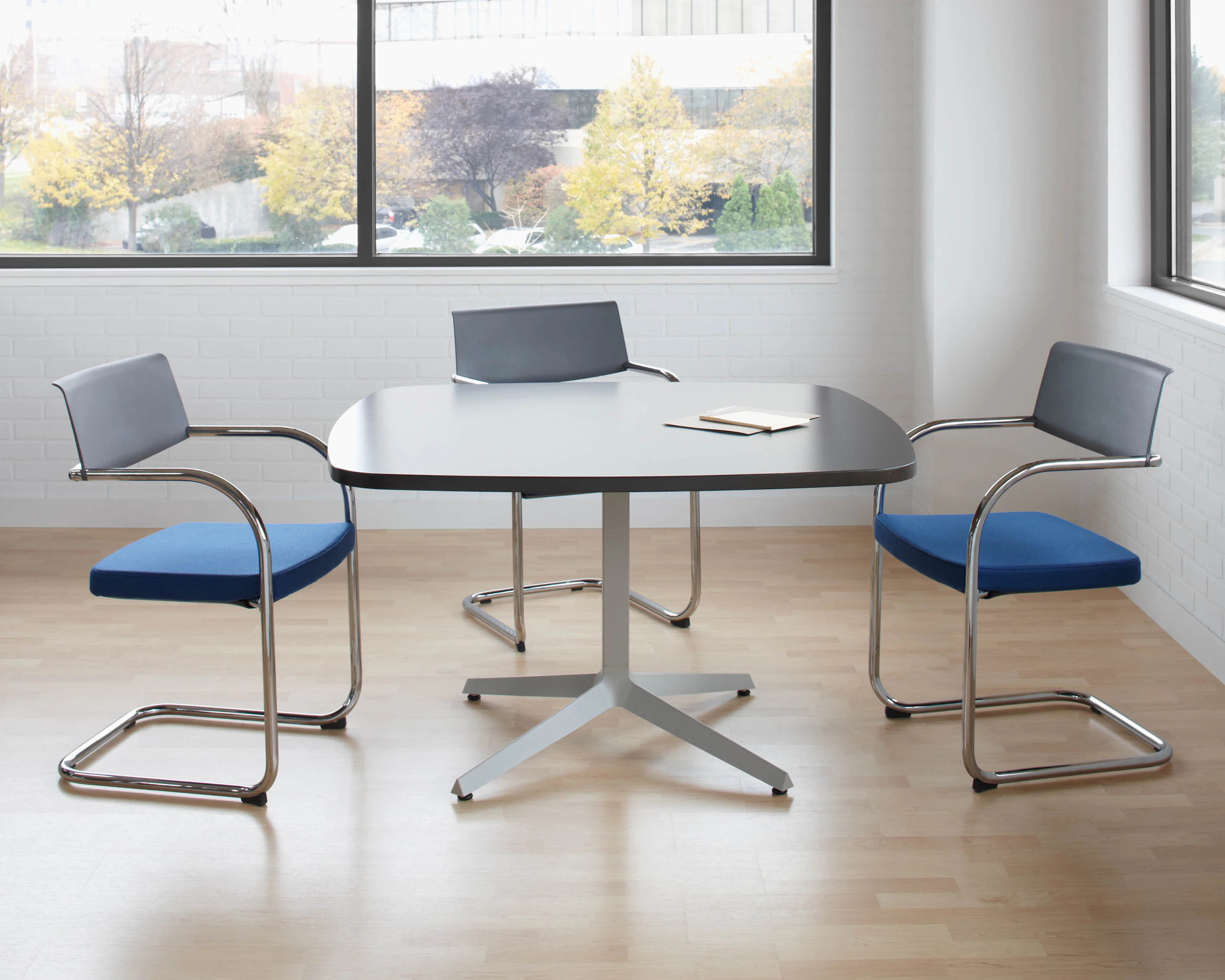 Dividends Skyline meeting table with Moment side chairs.