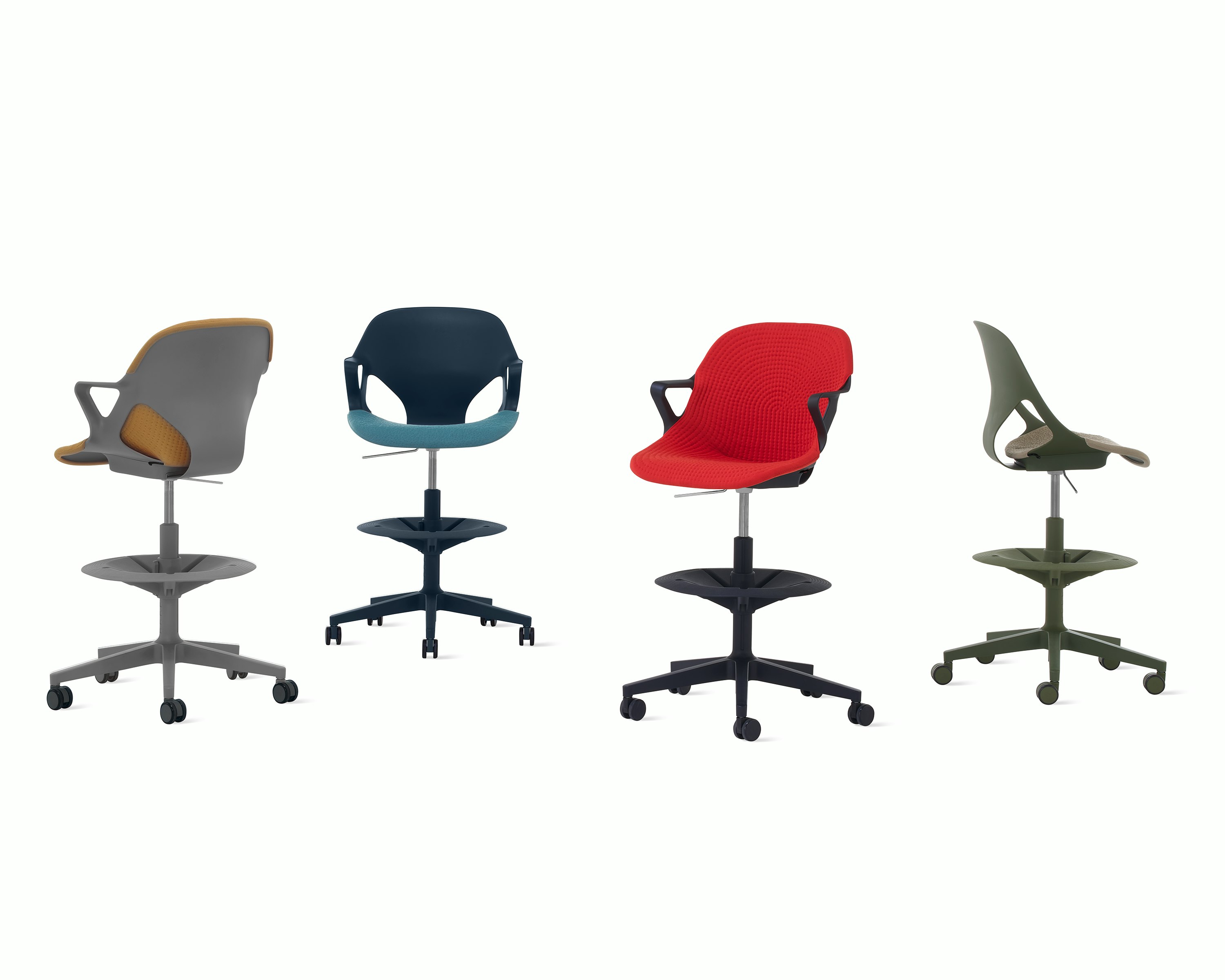 Four Zeph Stools in various angles including a dark grey stool with brown knit cover, a dark blue stool with a light blue knit seat pad, a black stool with a red seat cover and a olive stool with a light pink seat pad.