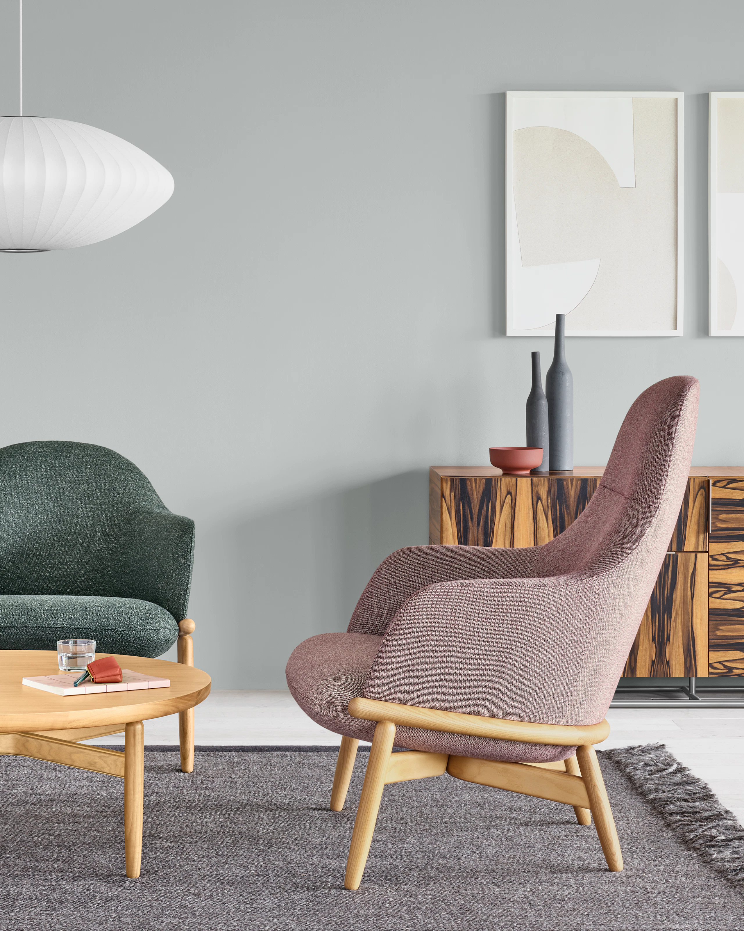 An office environment featuring two Reframe Lounge Chairs and a Reframe Table.