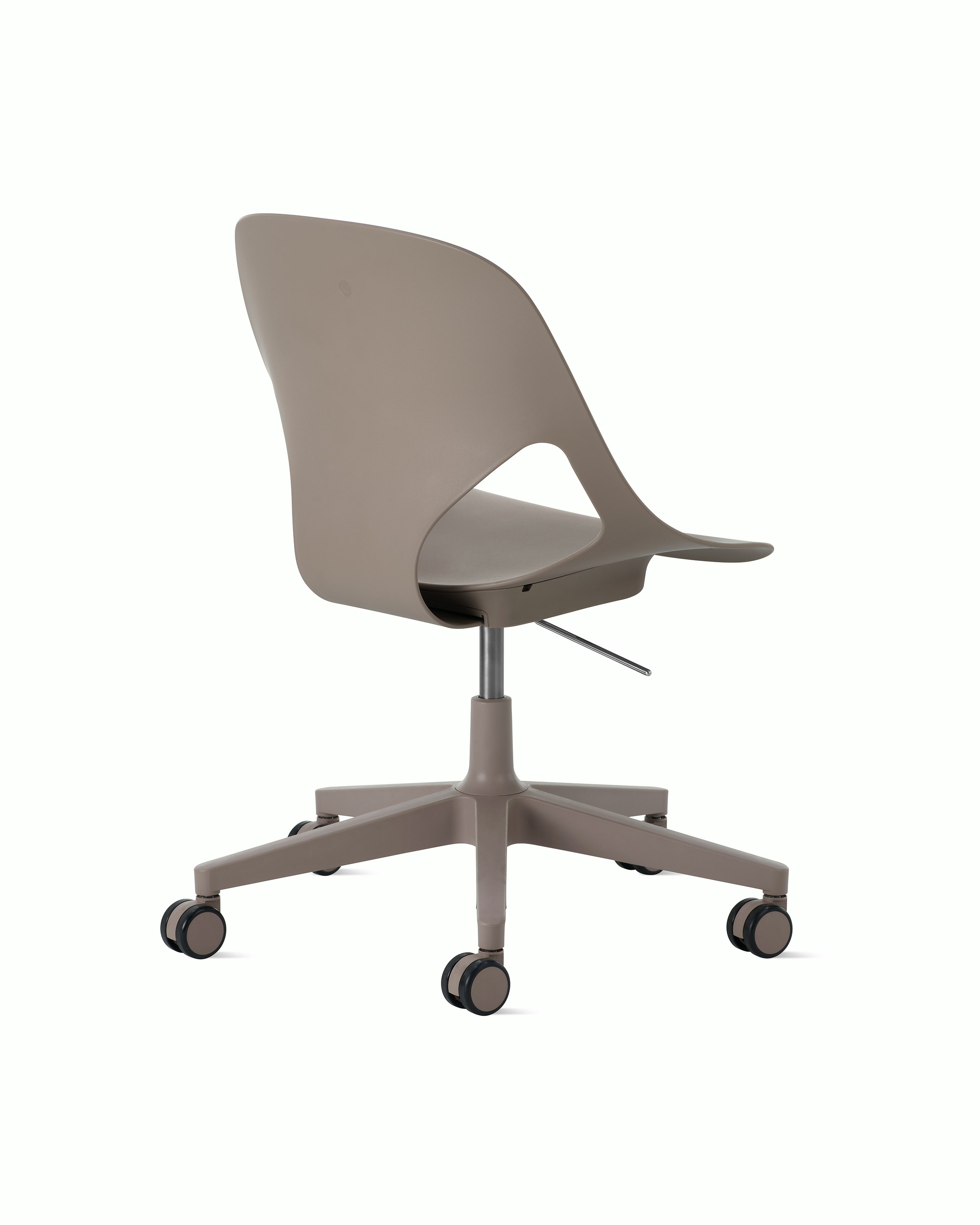 Rear angle view of a light brown armless Zeph chair.