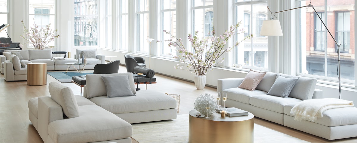 Tolomeo Floor Lamp positioned next to a Reid One Arm Sofa in a living room setting