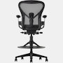 Black matte Aeron Stool on a white background with a 5-star base and ergonomic back support, view of the chair back.