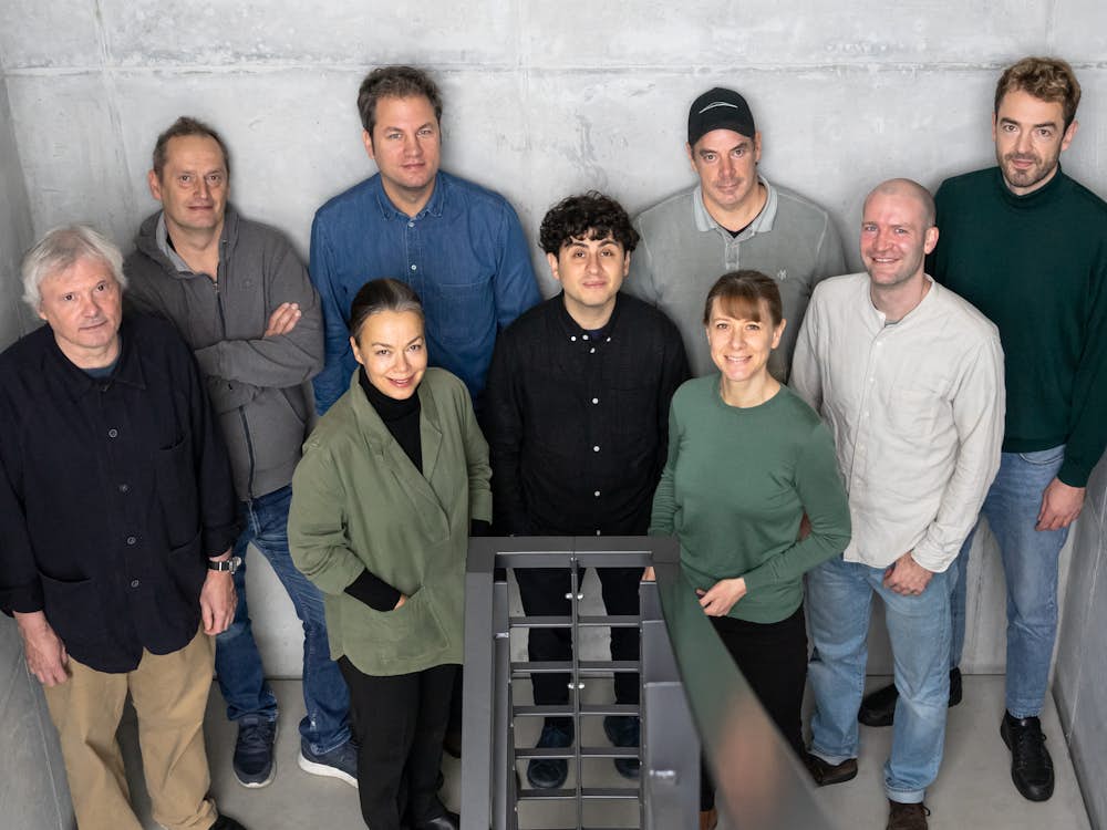 The Studio 7.5 design team standing together in a group in a stairwell.https://images.hermanmiller.group/m/7bf1abf8ab8c679a/W-HM_seven5_designer_grid_1.png?auto=format&mediaId=B459A6A8-7706-405E-AC6EEE155D10500A&rect=0%2C0%2C.9996%2C.9999