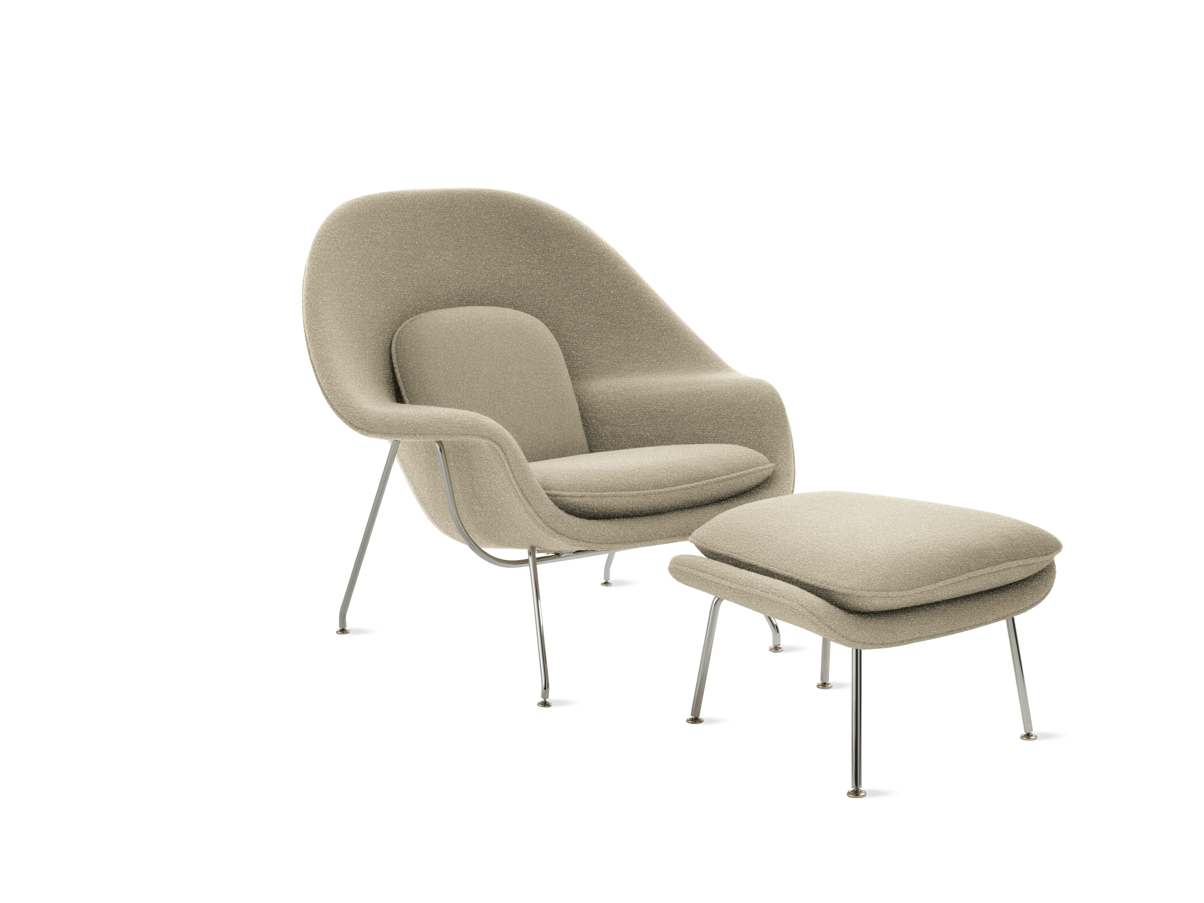 A neutral Womb Chair & Ottoman viewed from an angle