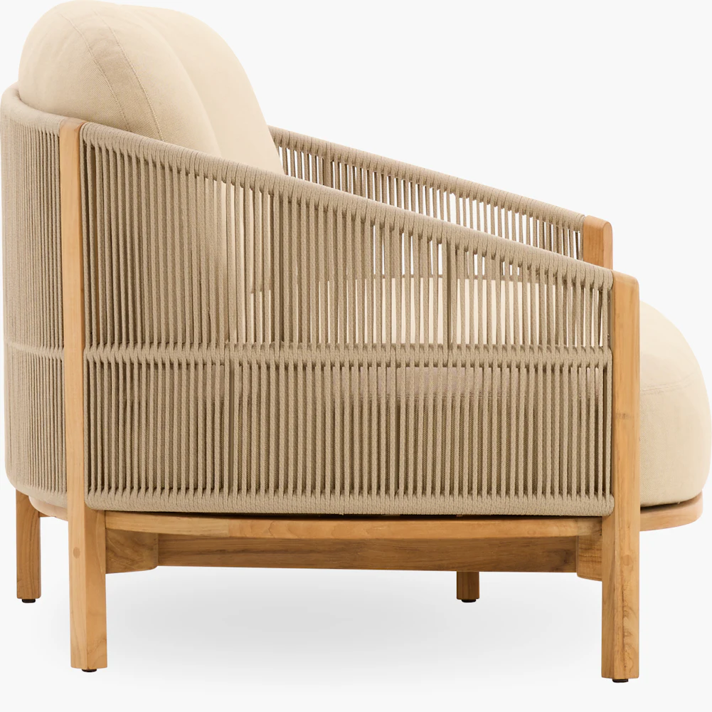 Side view of beige cushioned armchair with wooden frame and vertical rope detailing