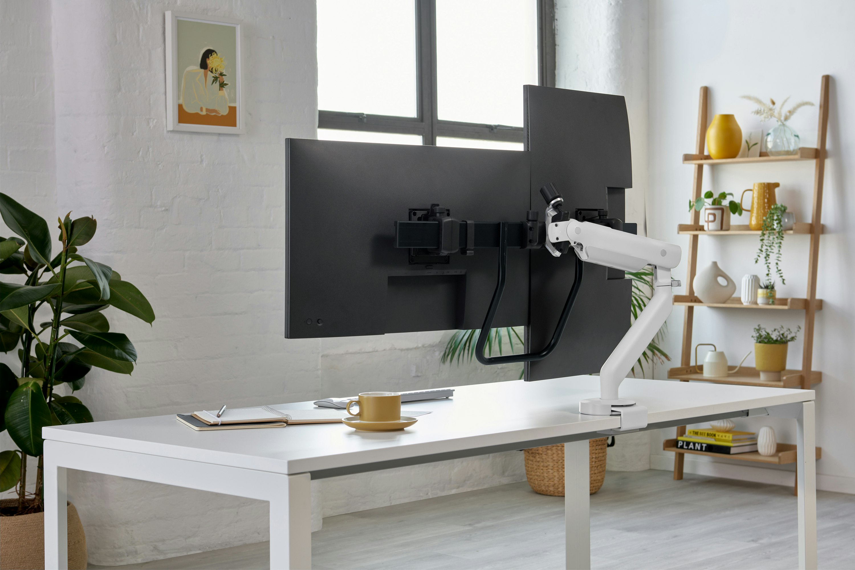 White dual Flo X monitor arm set up, viewed from an angle