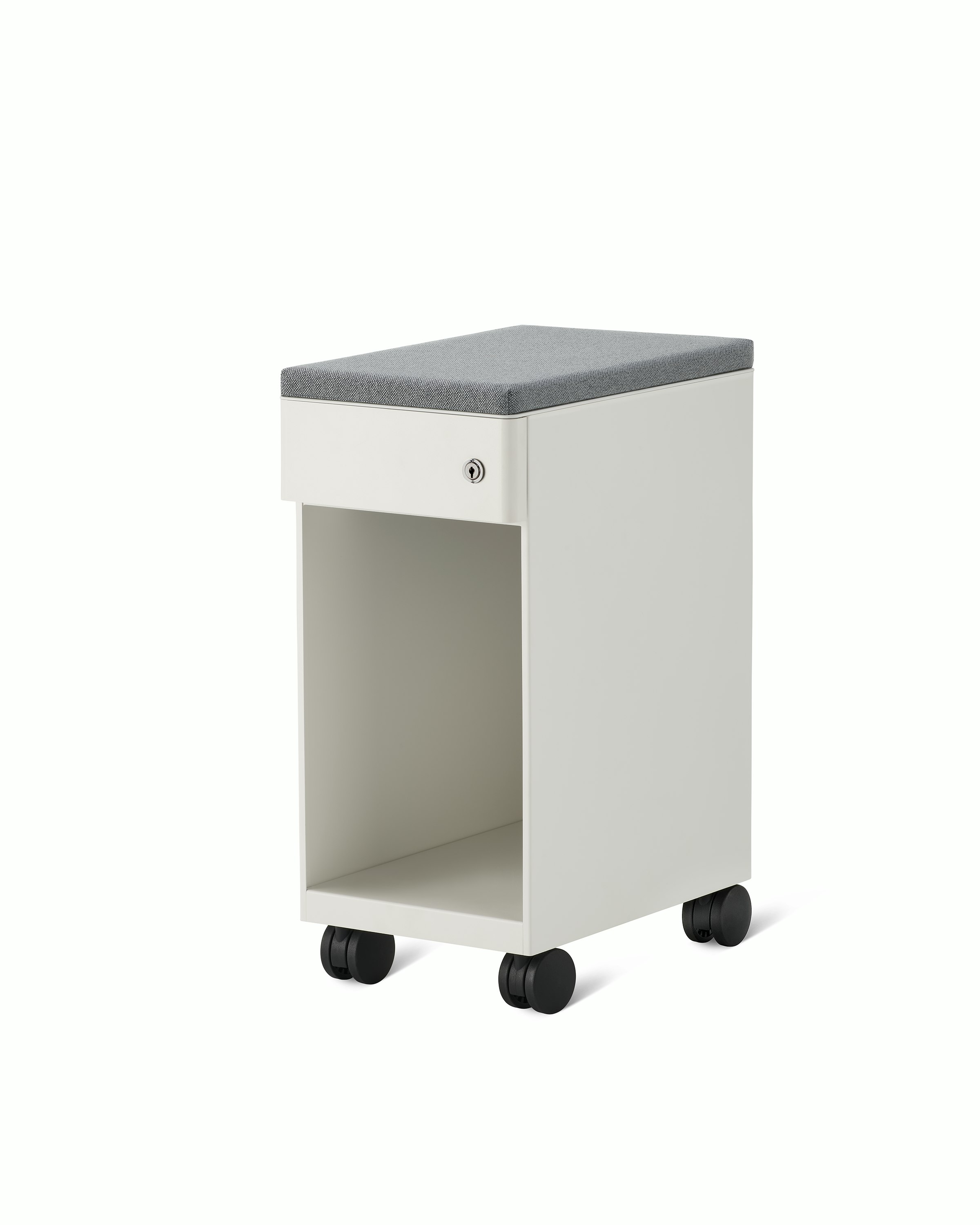 Slim, white storage pedestal on casters with a drawer and a lock, a gray cushion on top, and opening below drawer for storage.