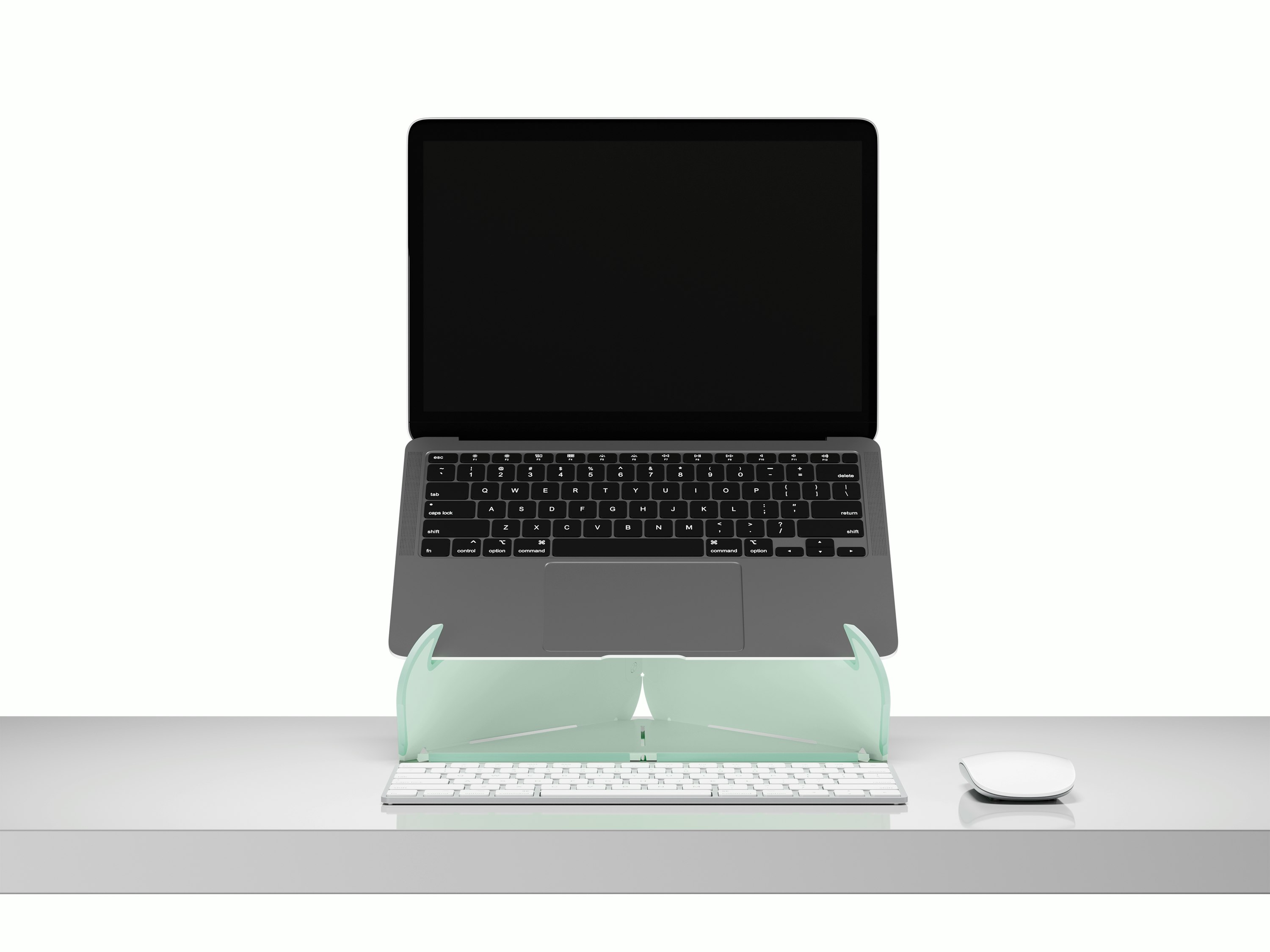 An open laptop raised to eye level on an Oripura Laptop Stand In mint green placed on a desk with work tools.