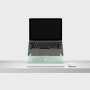 An open laptop raised to eye level on an Oripura Laptop Stand In mint green placed on a desk with work tools.