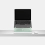 An open laptop raised to eye level on an Oripura Laptop Stand In mint green placed on a desk with work tools.
