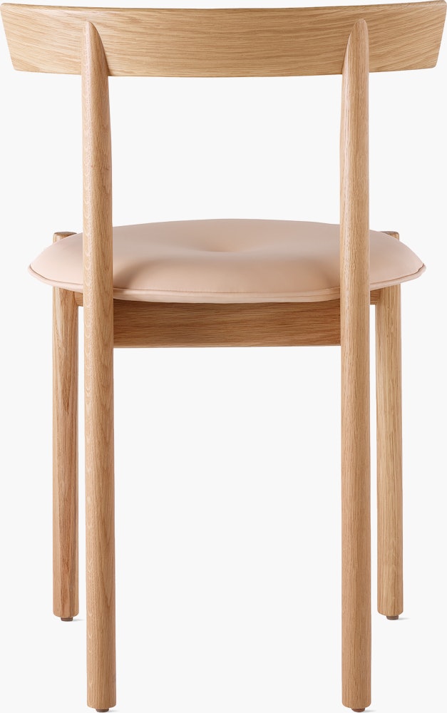 An oak Comma Chair with a seat pad, viewed from the back.