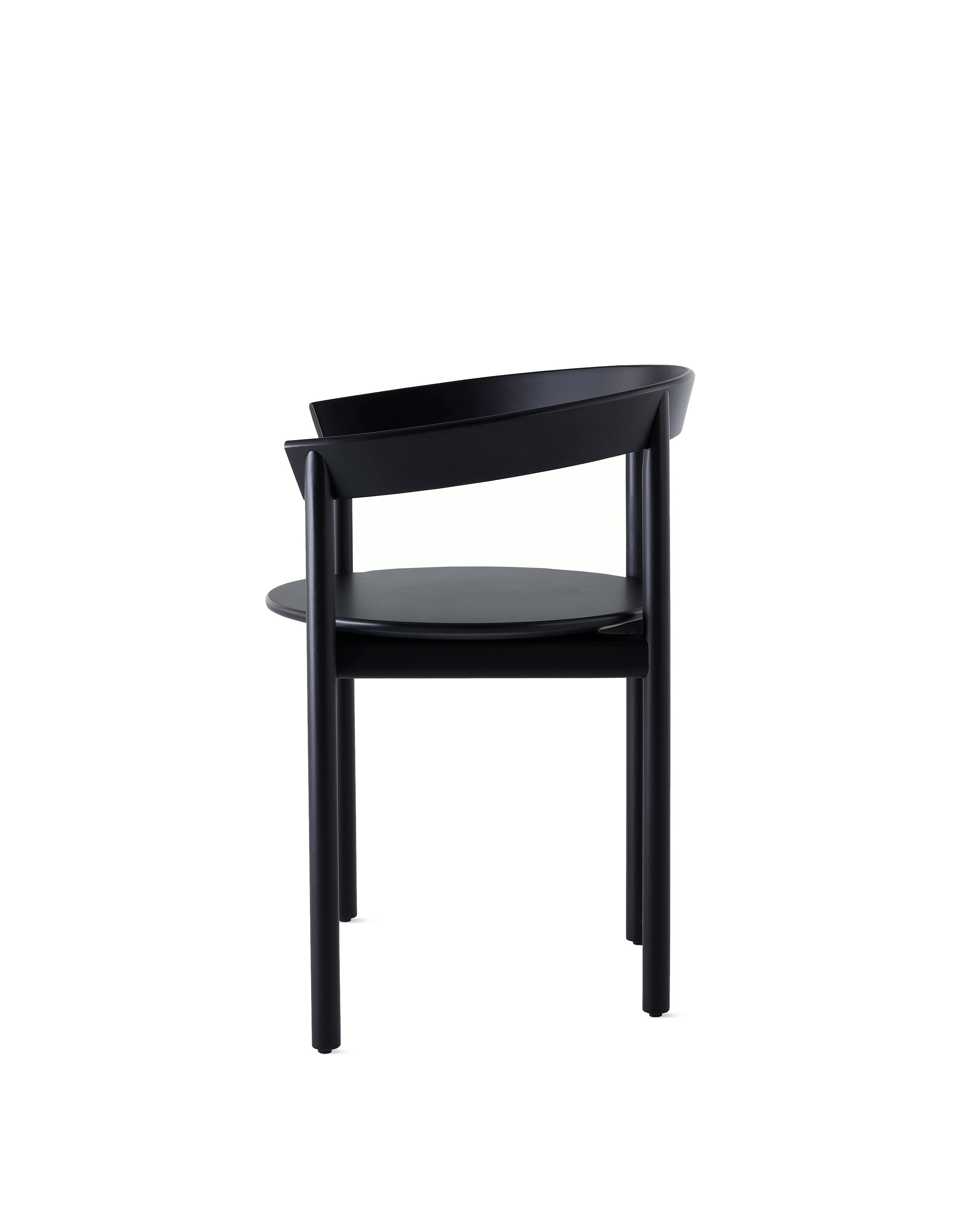 Profile view of a black Comma Chair with arms.