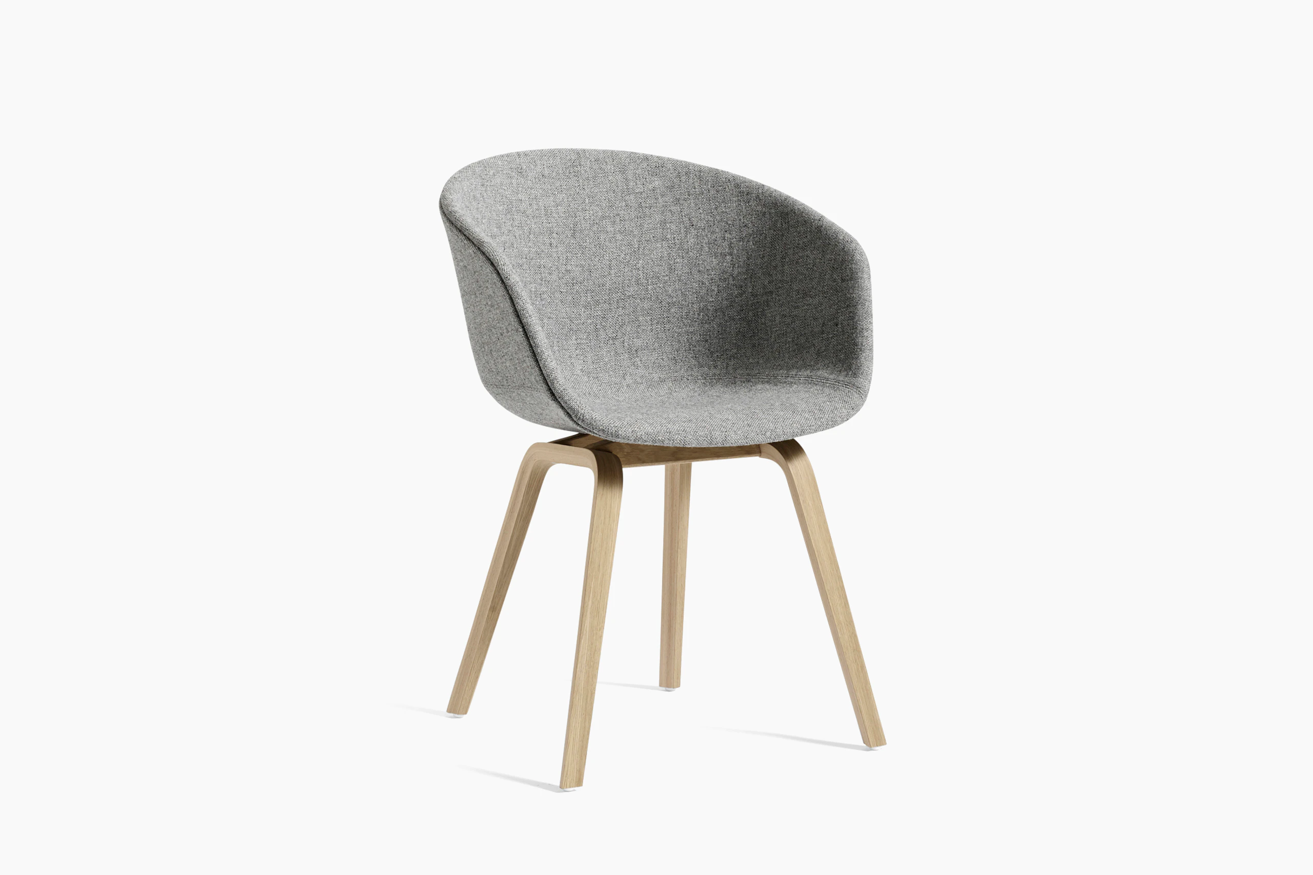 Grey upholstered About A Chair with wooden base, viewed at an angle.