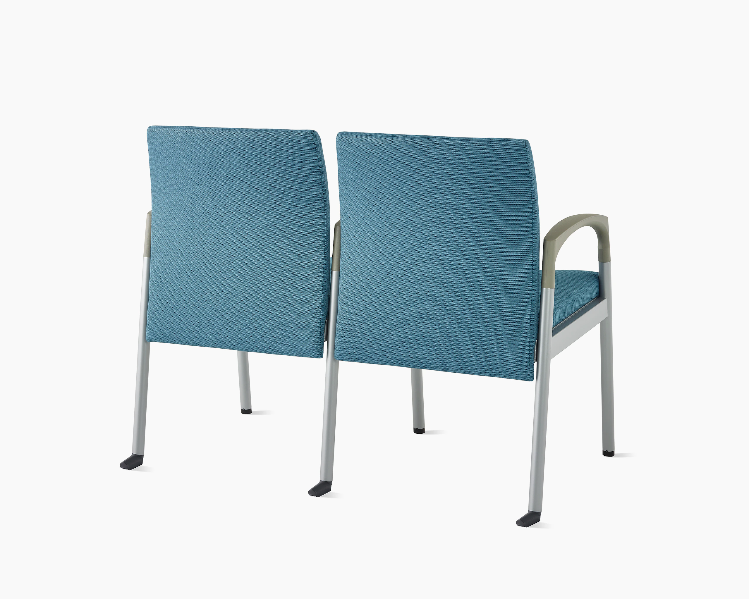 Three-quarter, back view of Valor two-seat multple seating with intervening arms and legs in a blue upholstery, silver frame, and pewter armcaps on white sweep.