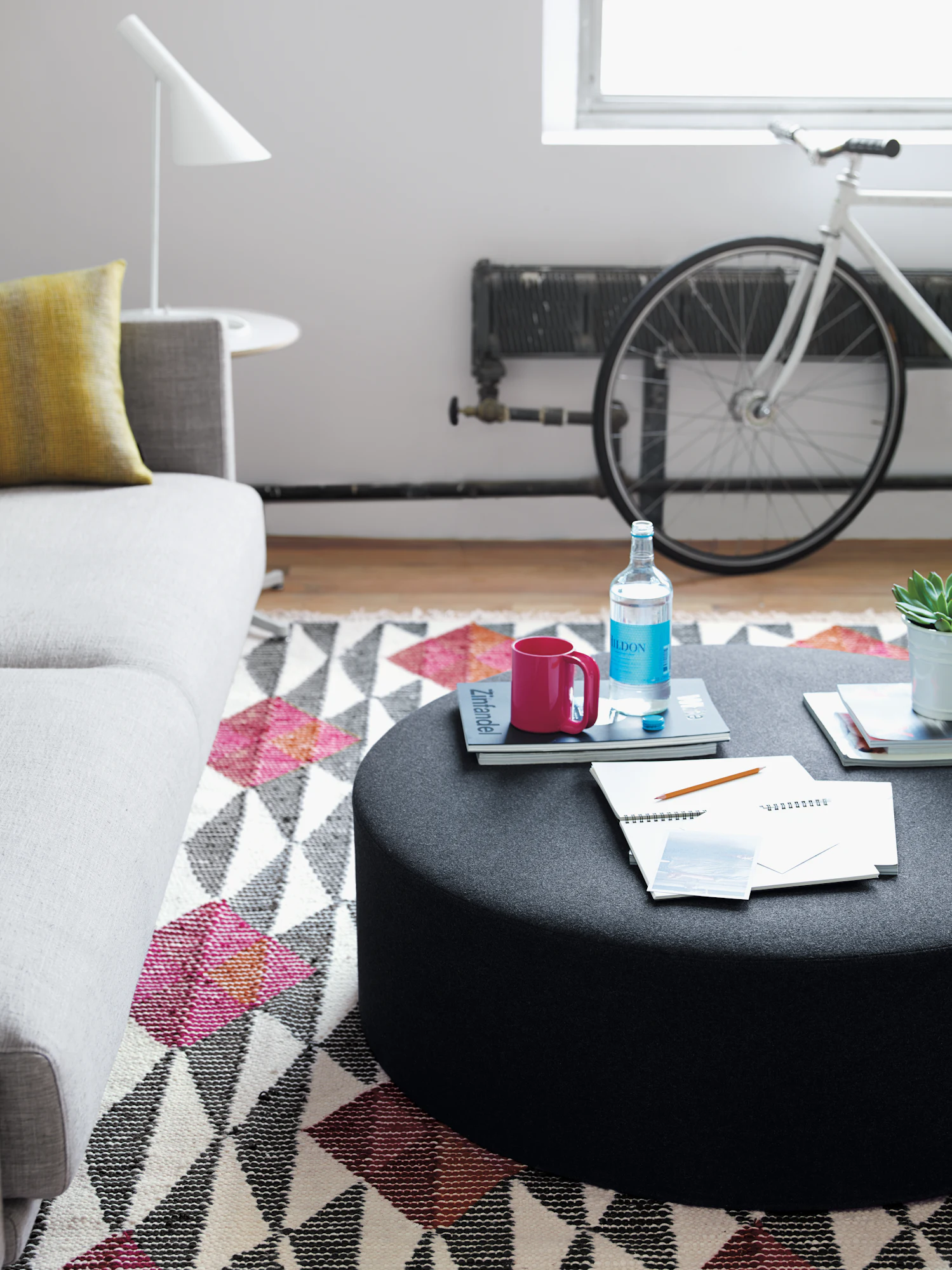 Dark grey wide drum pouf with rounded seat