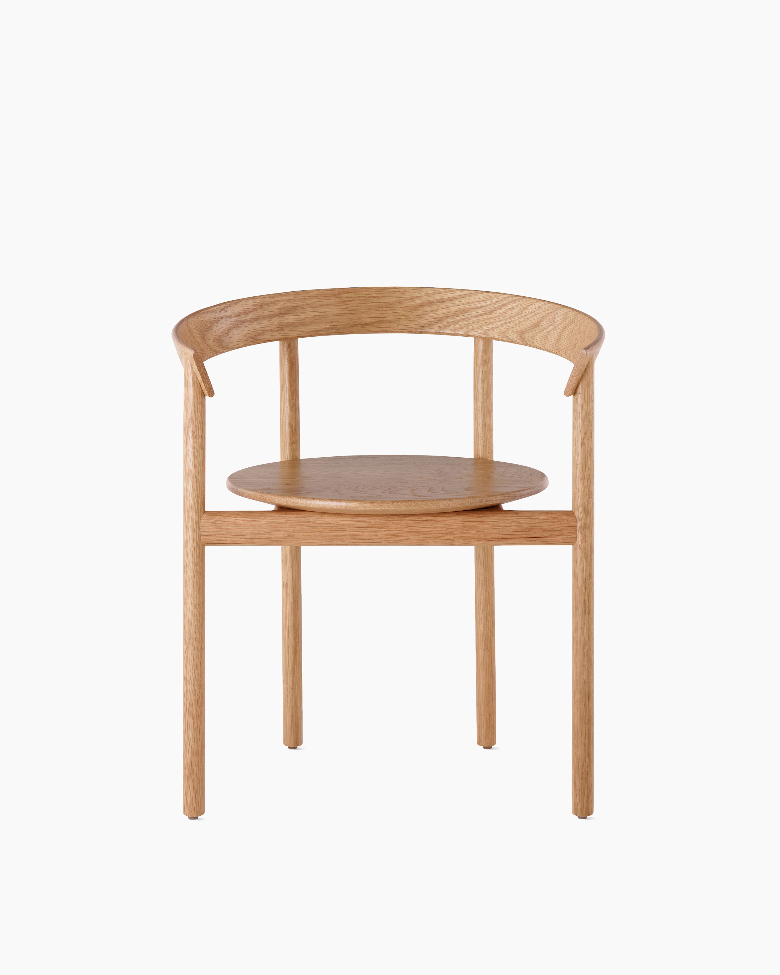 An oak Comma Chair with arms, viewed from the front.