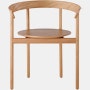 An oak Comma Chair with arms, viewed from the front.
