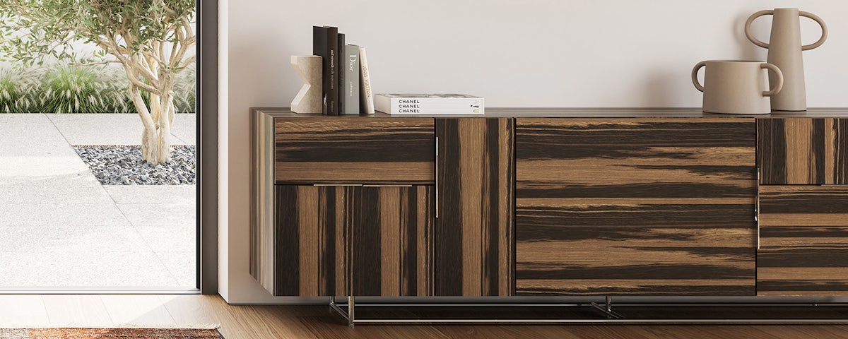Domino Credenza holding books and vases in a living room setting